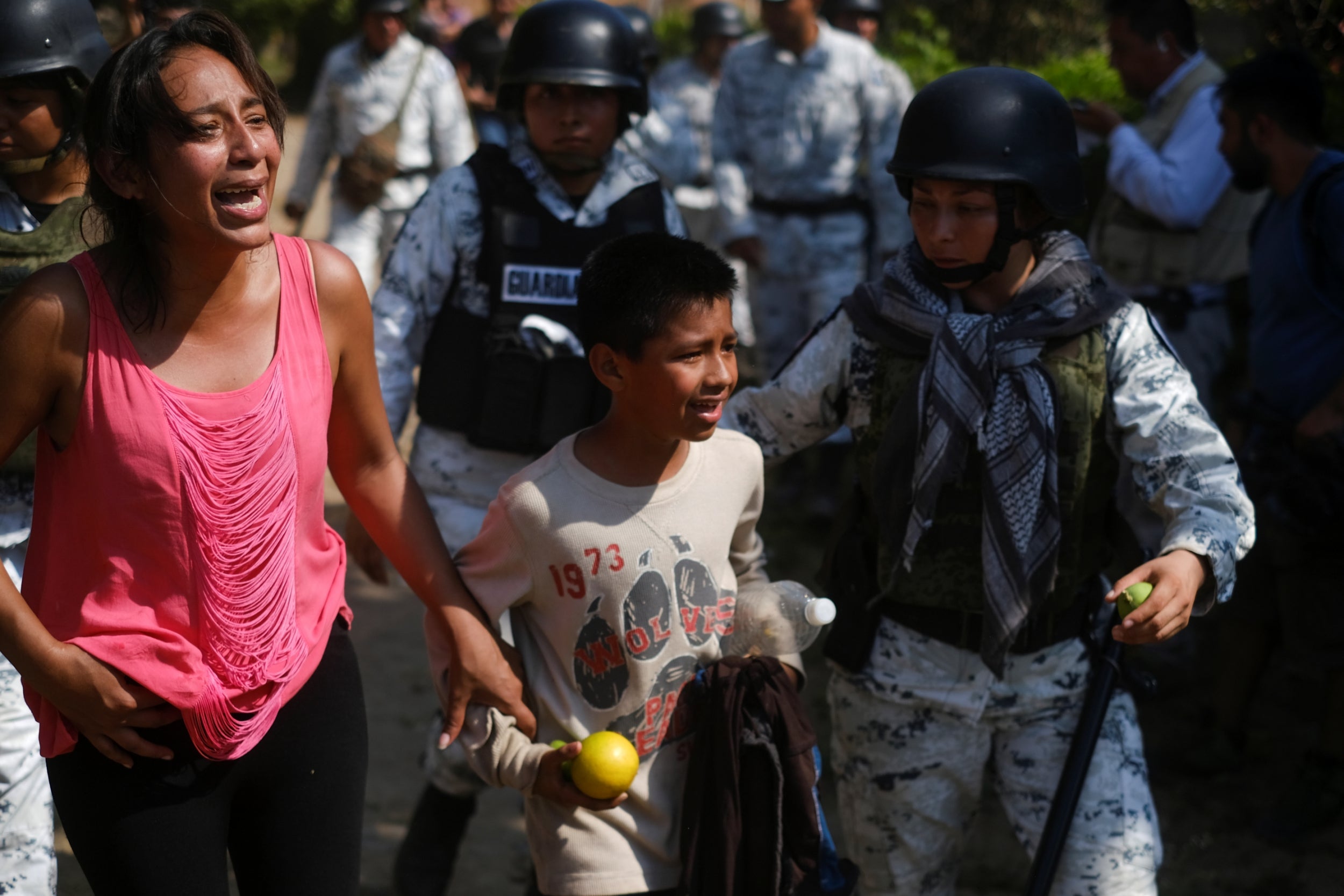 Migrants are detained by Mexican security forces near the US border at Frontera Hidalgo