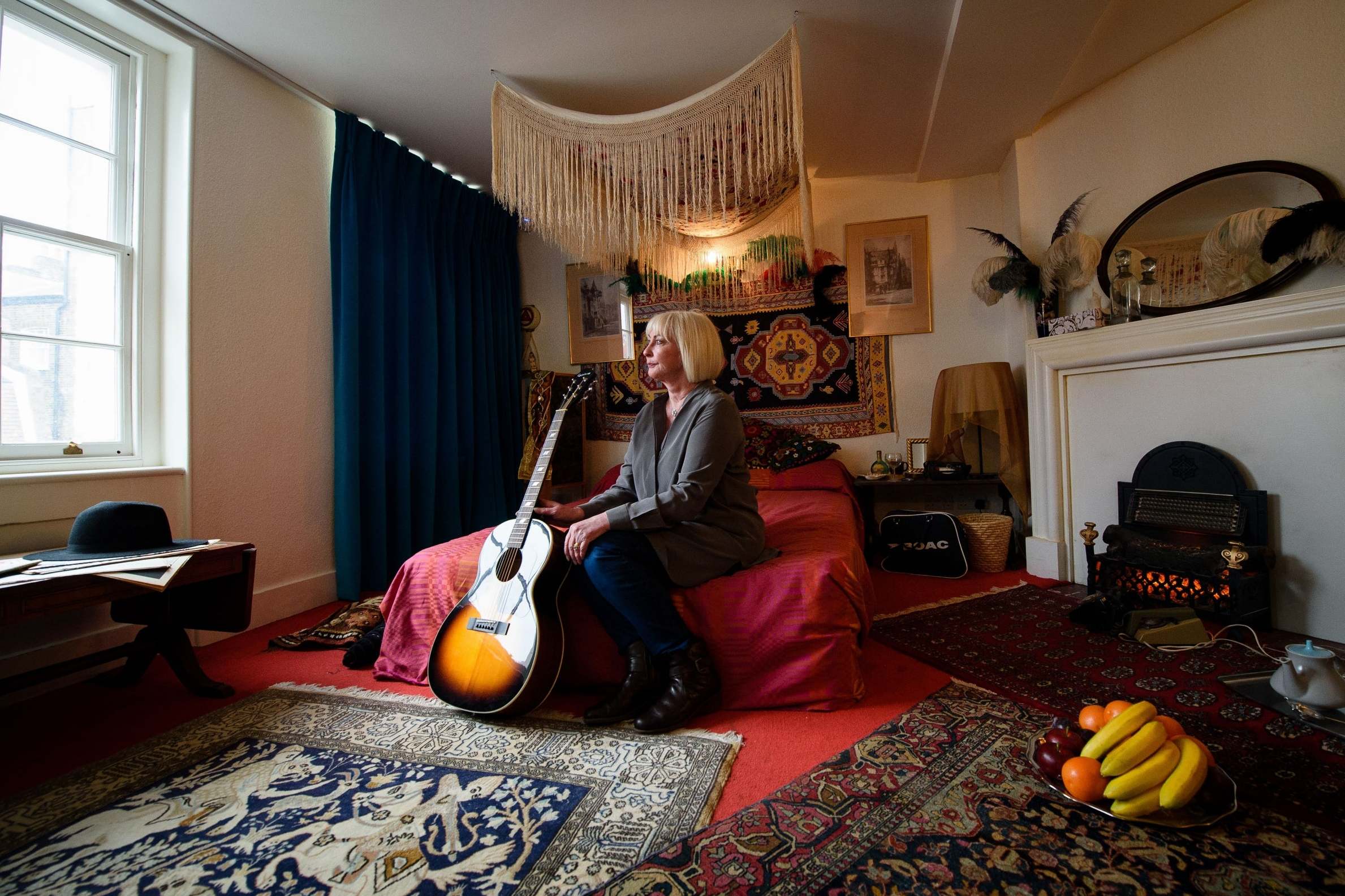 Former girlfriend of Jimi Hendrix Kathy Etchingham poses with one of his guitars in a recreation of their bedroom (AFP/Getty)