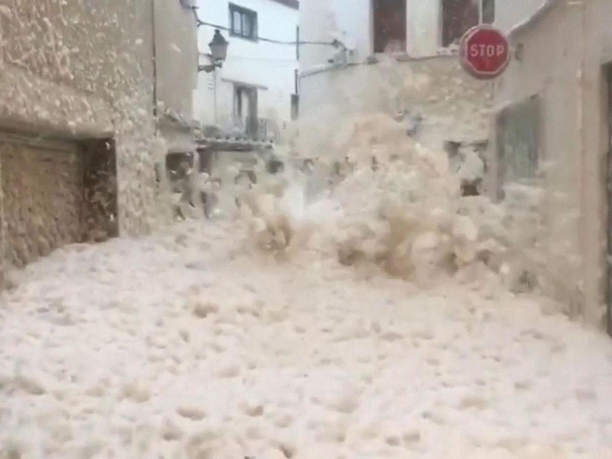Spanish town submerged in sea foam as tidal surge sweeps miles inland