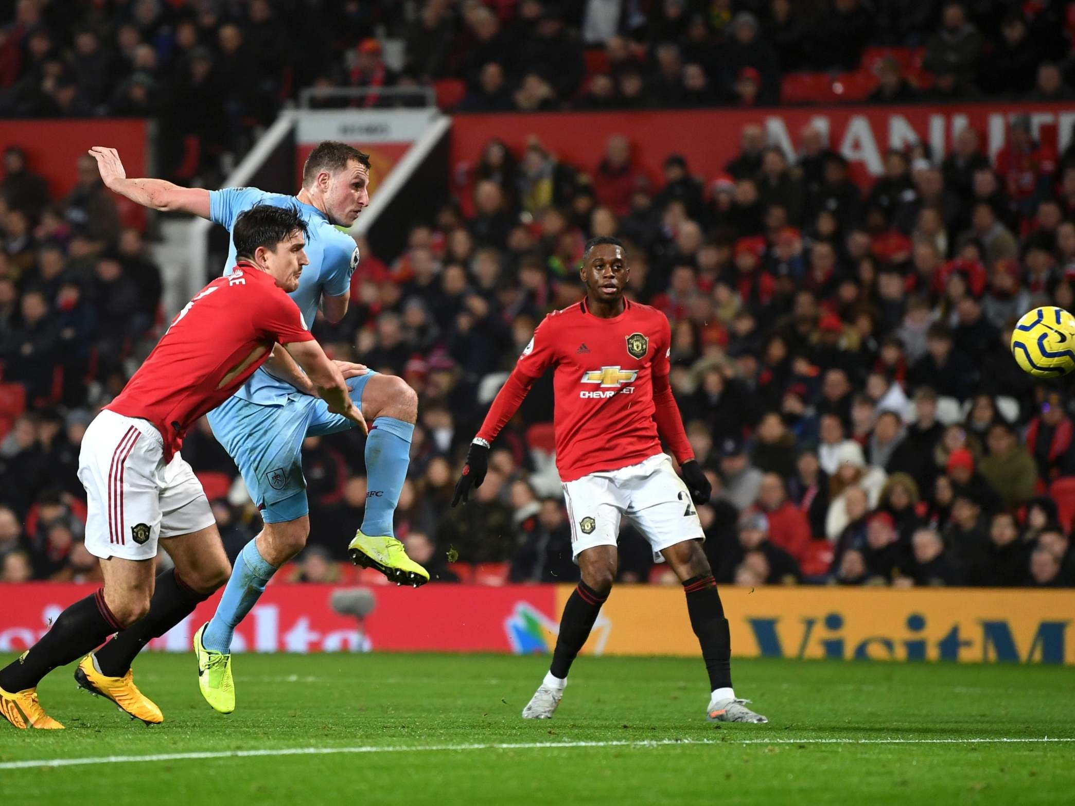 Harry Maguire cannot stop Chris Wood from firing home the first goal