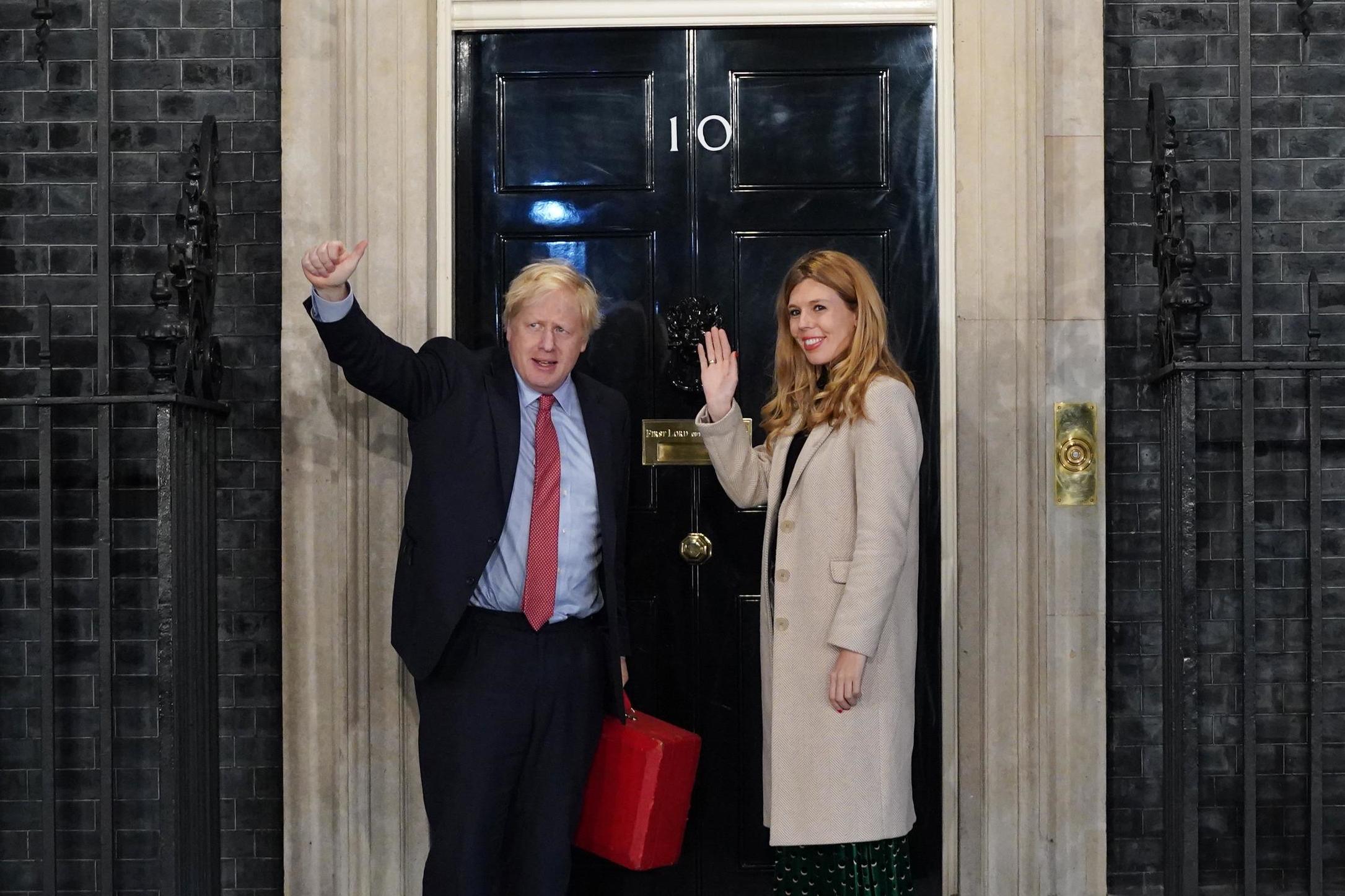 Boris Johnson and his partner, Carrie Symonds, enter Downing Street as the Conservatives celebrate victory (Getty)