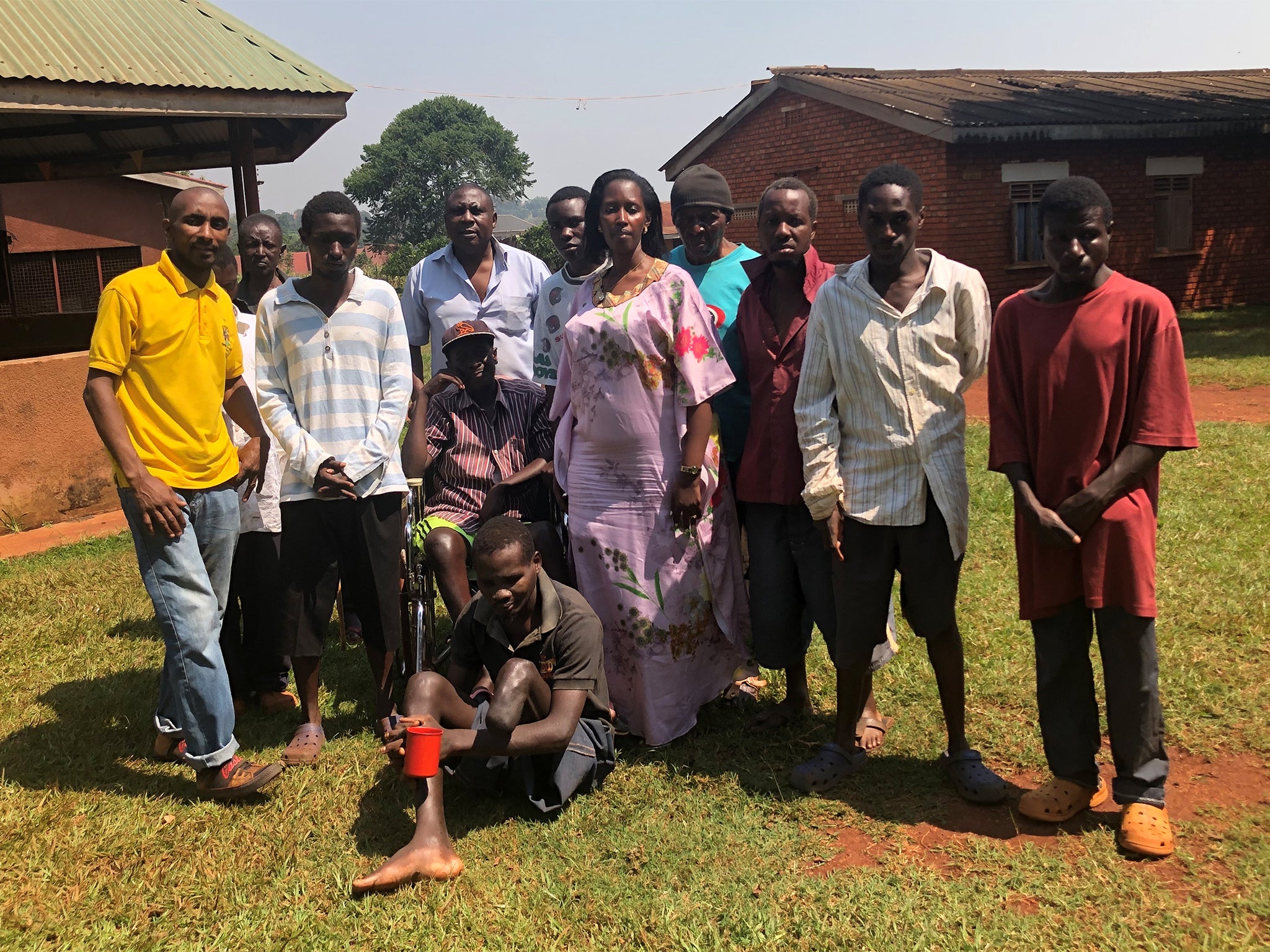 Street Resource founder Merry Ntungyire [C] with residents of the centre in Jinja