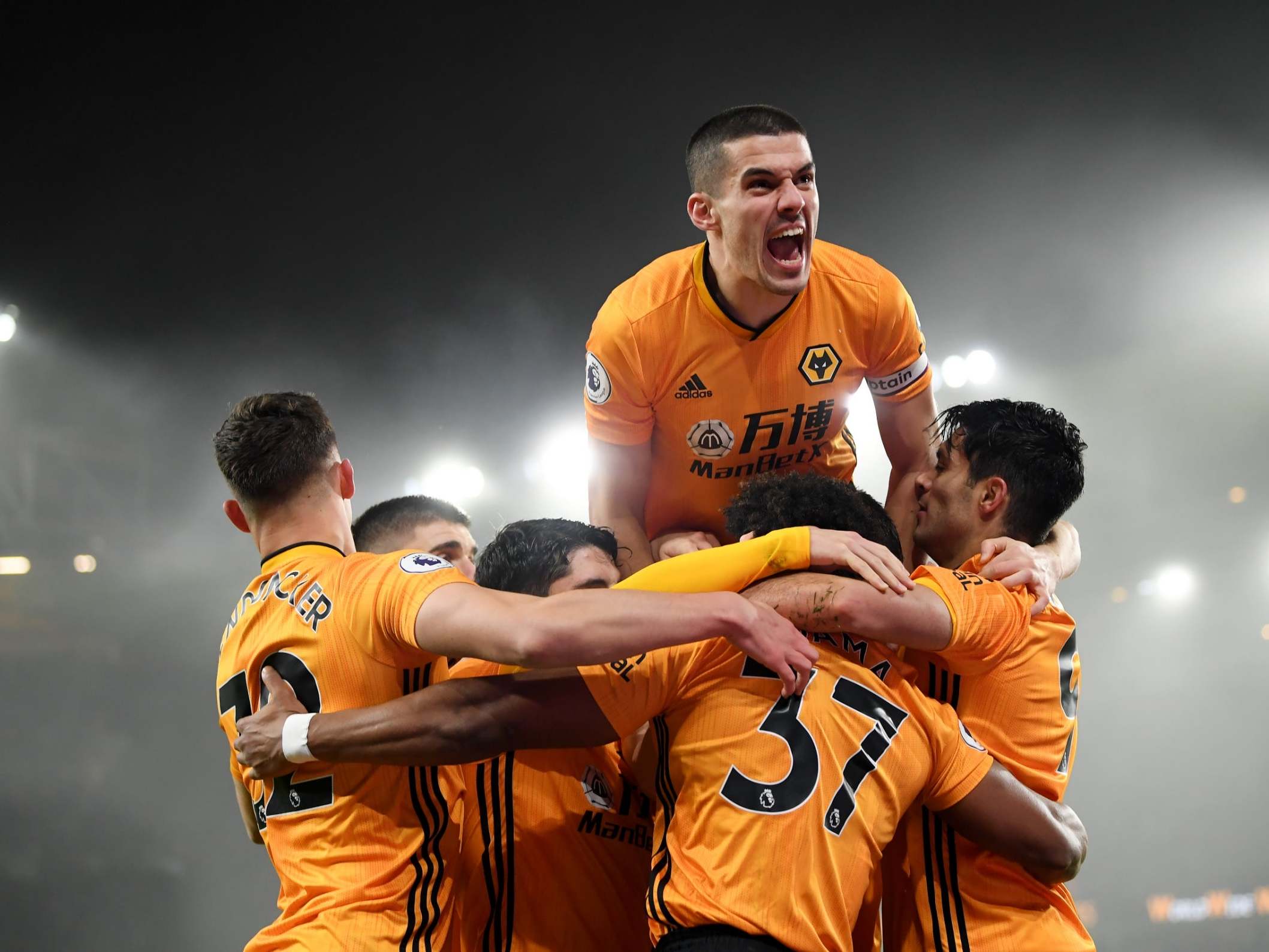 Conor Coady of Wolverhampton Wanderers jumps on his teammates as they celebrate Raul Jimenez scoring