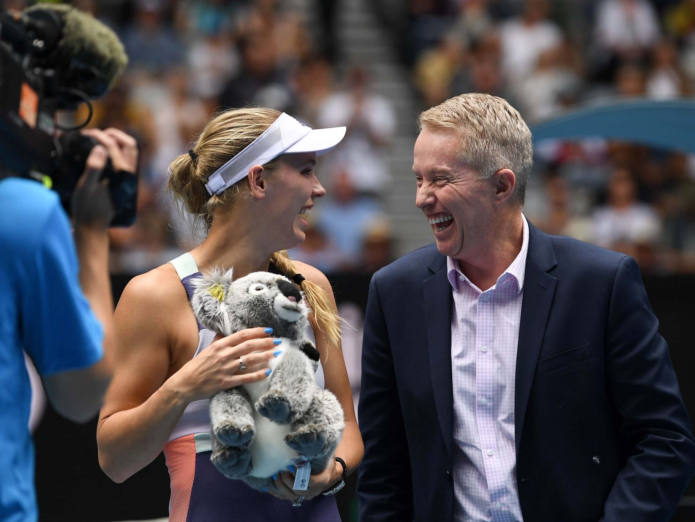 Caroline Wozniacki shares a joke with tournament director Craig Tiley