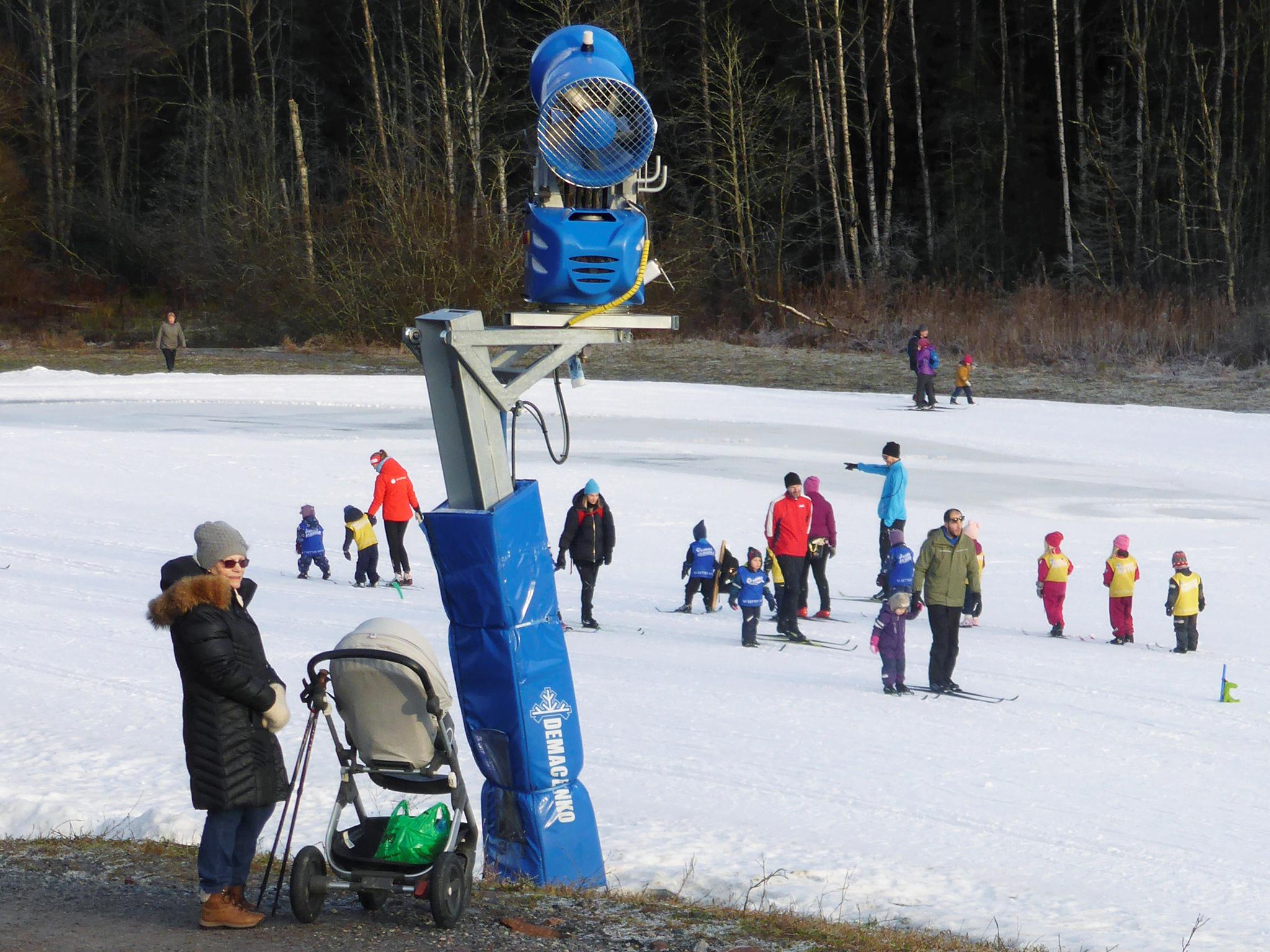 Children ski along on artificial snow in a forest in Oslo