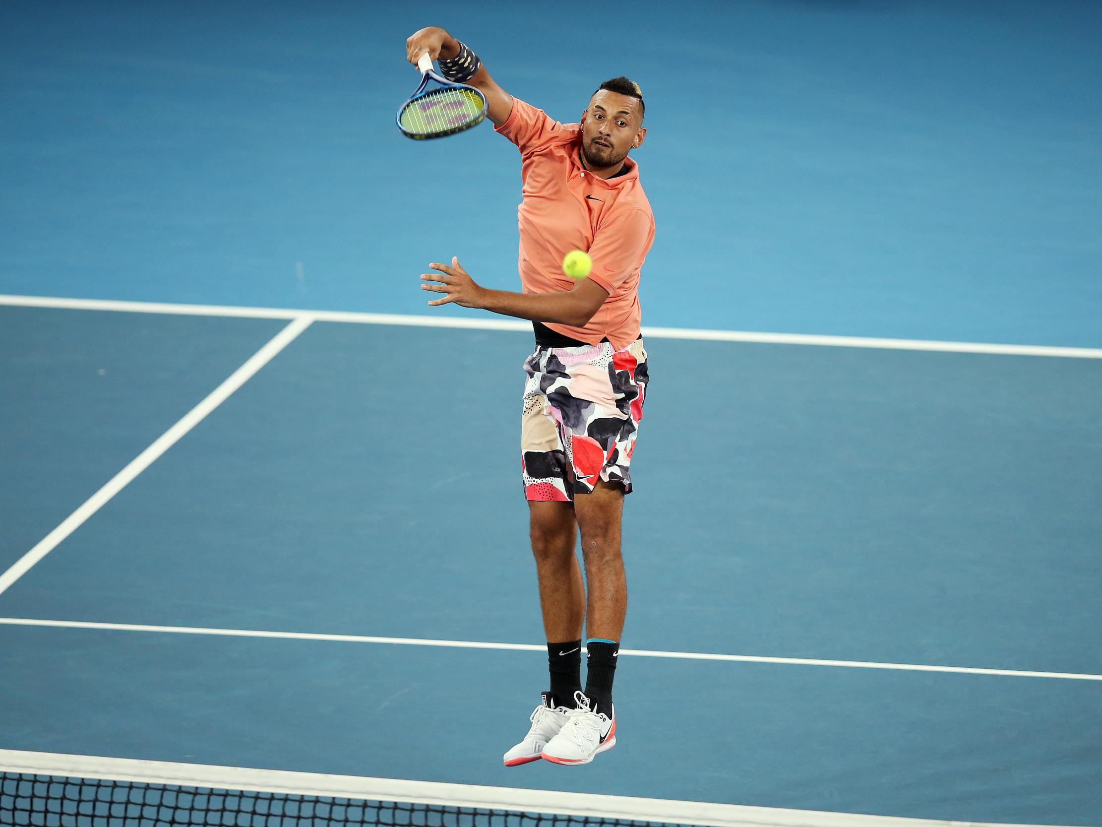 Nick Kyrgios plays an overhead shot against Karen Khachanov