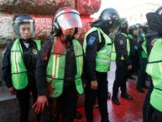 Red paint thrown at police as activists protest violence against women in Mexico