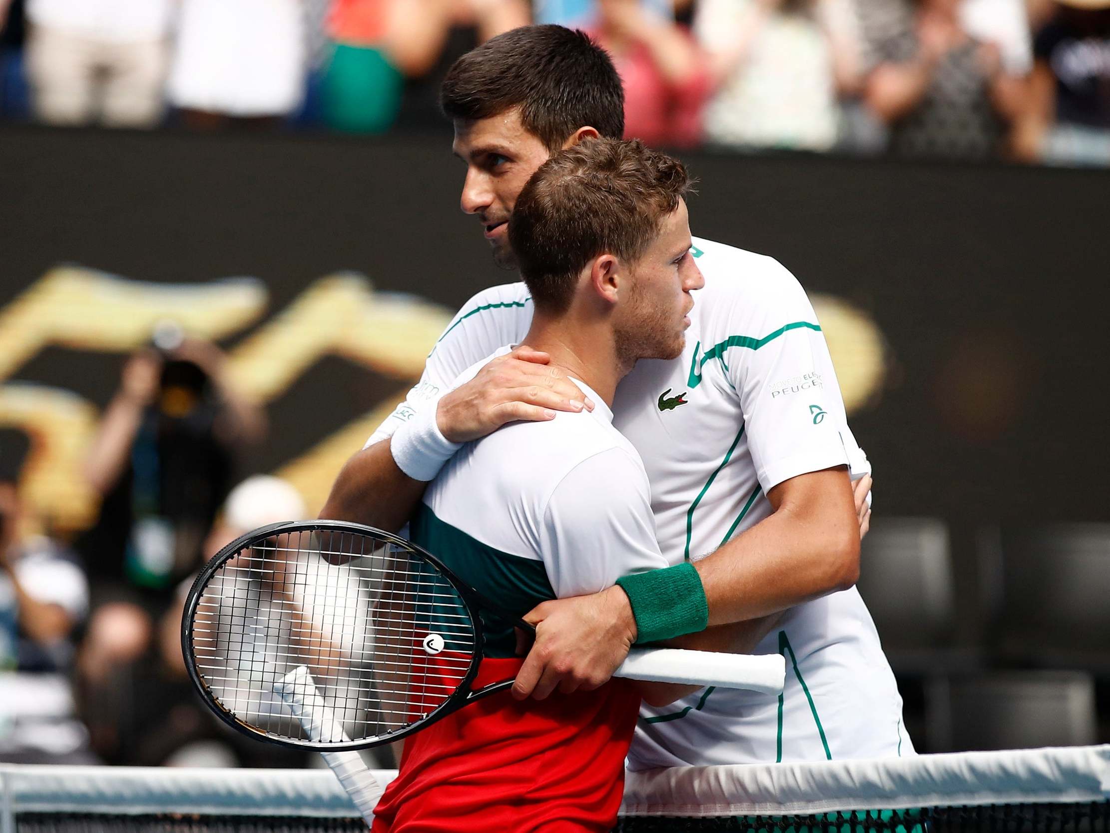 Novak Djokovic embarces Diego Schwartzman on Rod Laver Arena