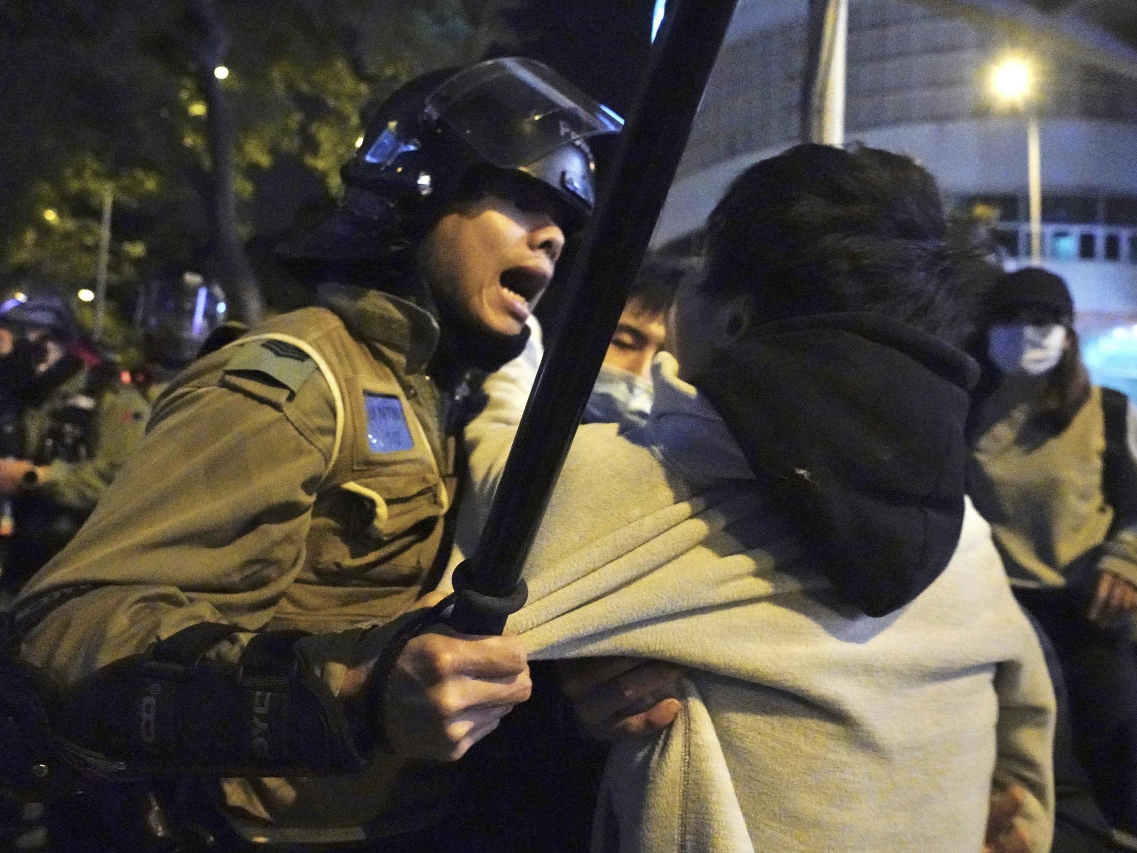 A local resident struggles with riot police at the Fai Ming Estate in Fanling district of Hong Kong Jan 26 2020, after the Hong Kong government announced it would requisition an unoccupied housing project to house quarantined patients