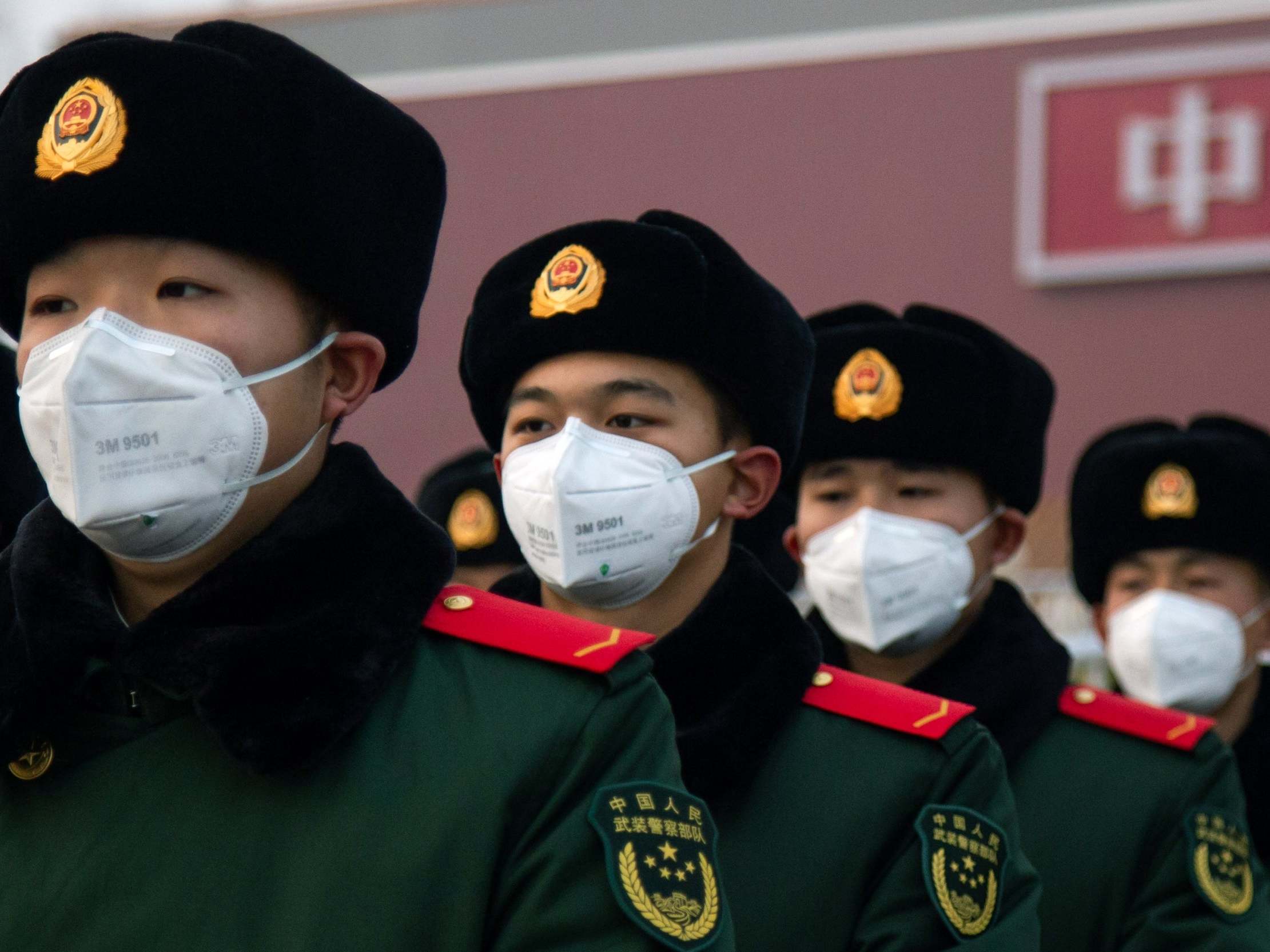 Chinese police officers wearing face masks stand in front of the Tiananmen Gate in Beijing, China, on 26 January 2020. ( Betsy Joles/Getty Images)