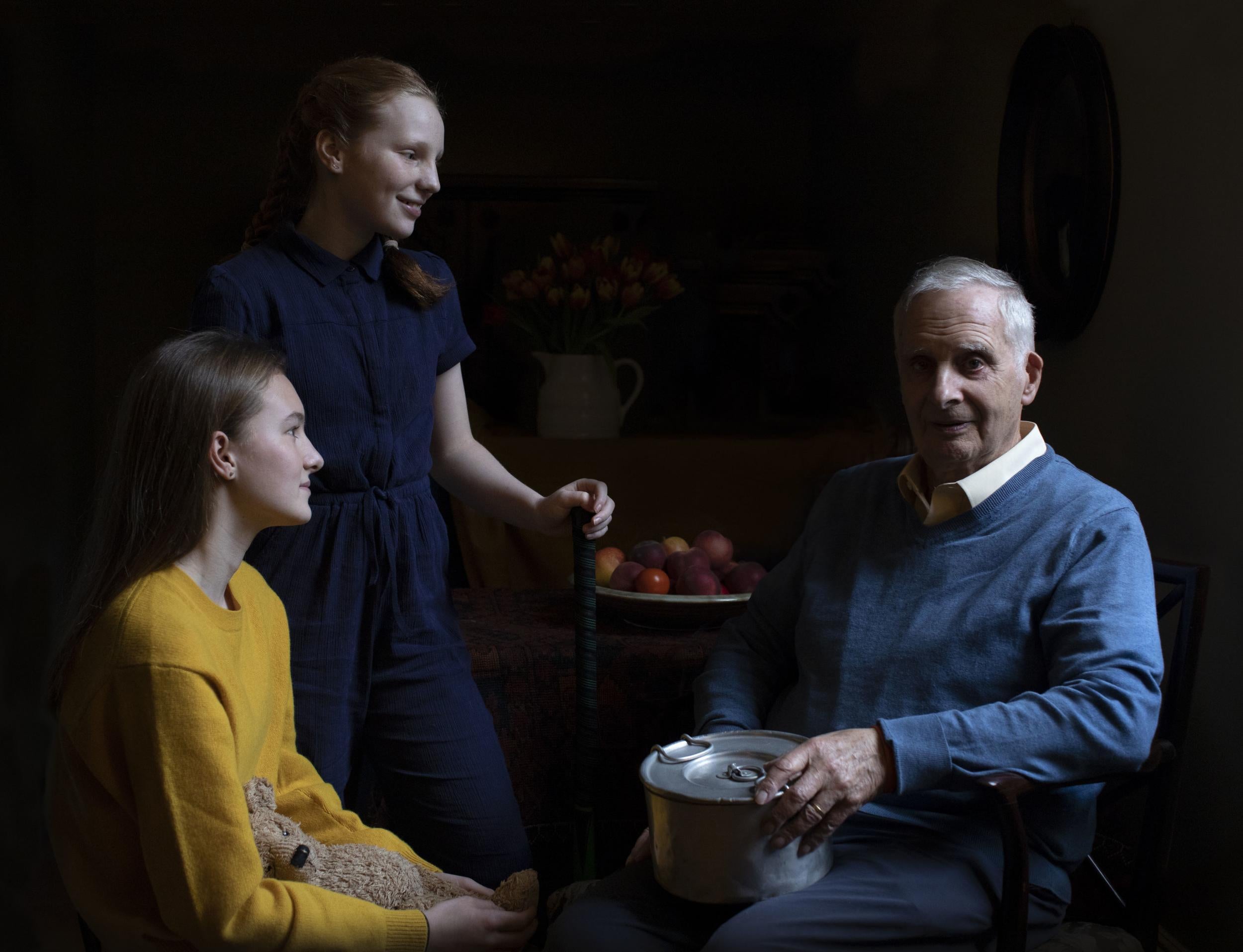 Steven Frank, 84, is pictured with his granddaughters Maggie and Trixie Fleet, aged 15 and 13 (PA)