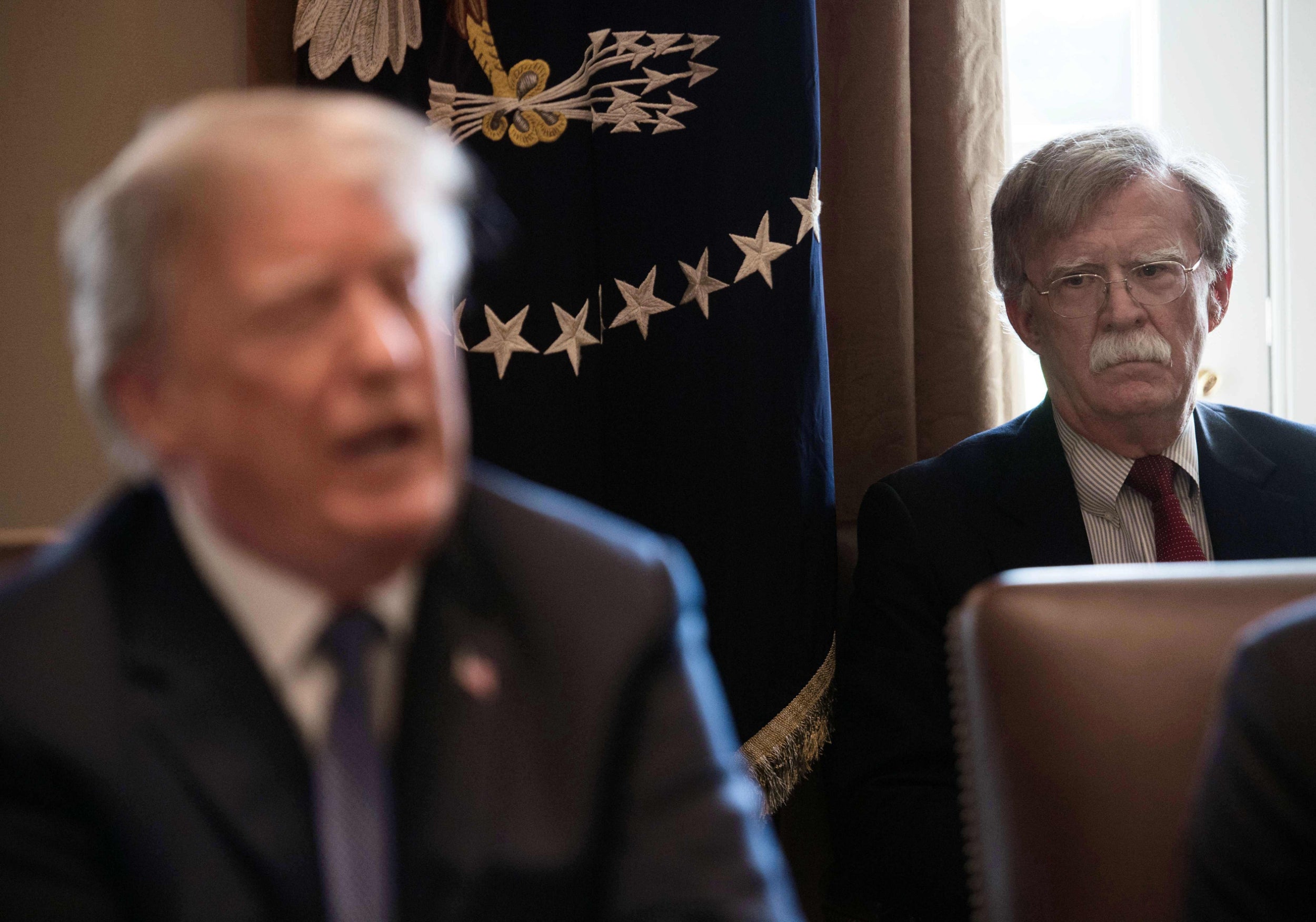 Former national security adviser John Bolton looks on as Donald Trump speaks at the White House. AFP via Getty Images