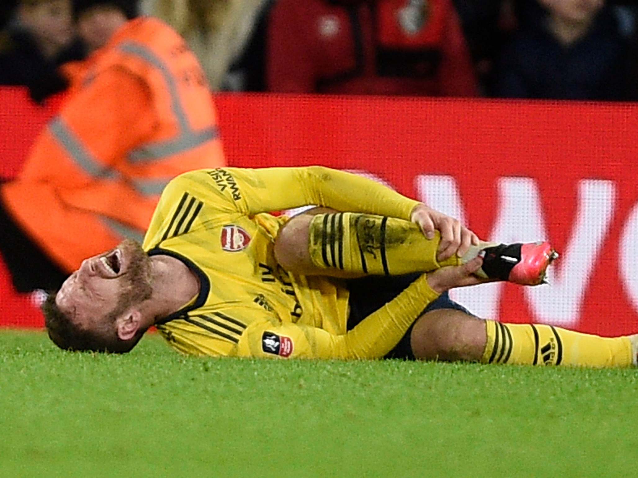 Shkodran Mustafi of Arsenal goes down injured