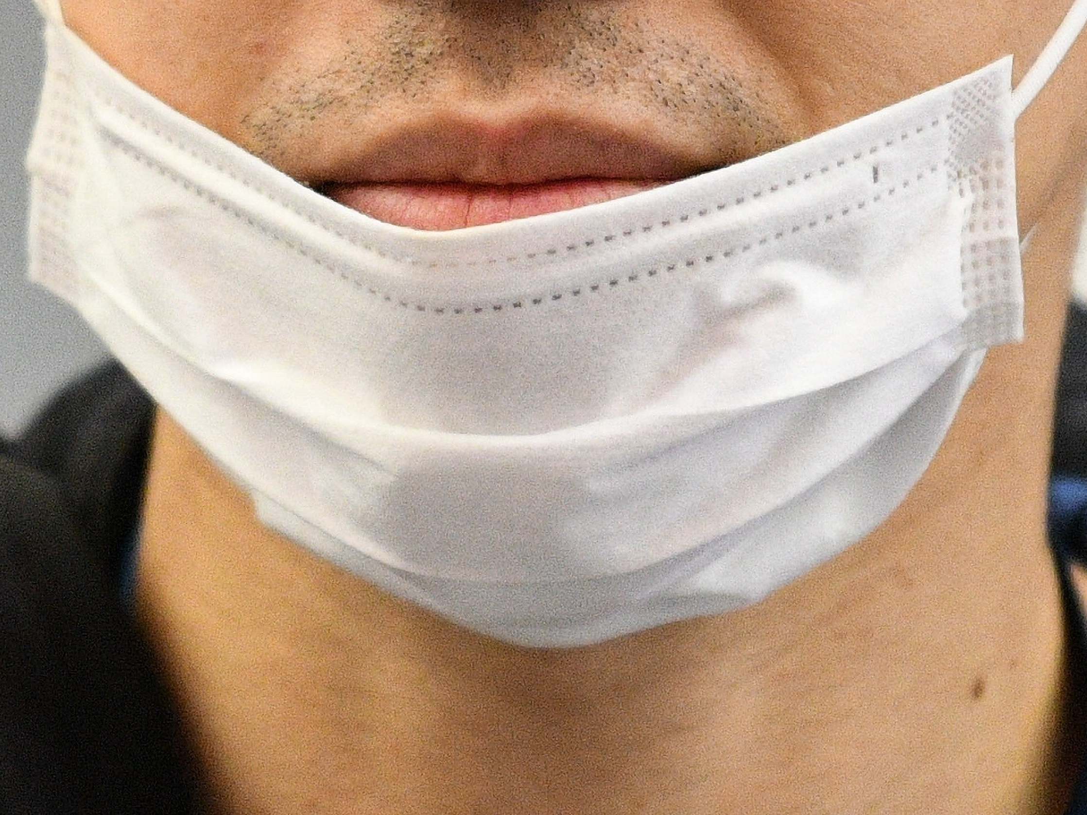 A traveller wears a face mask at an airport in Germany