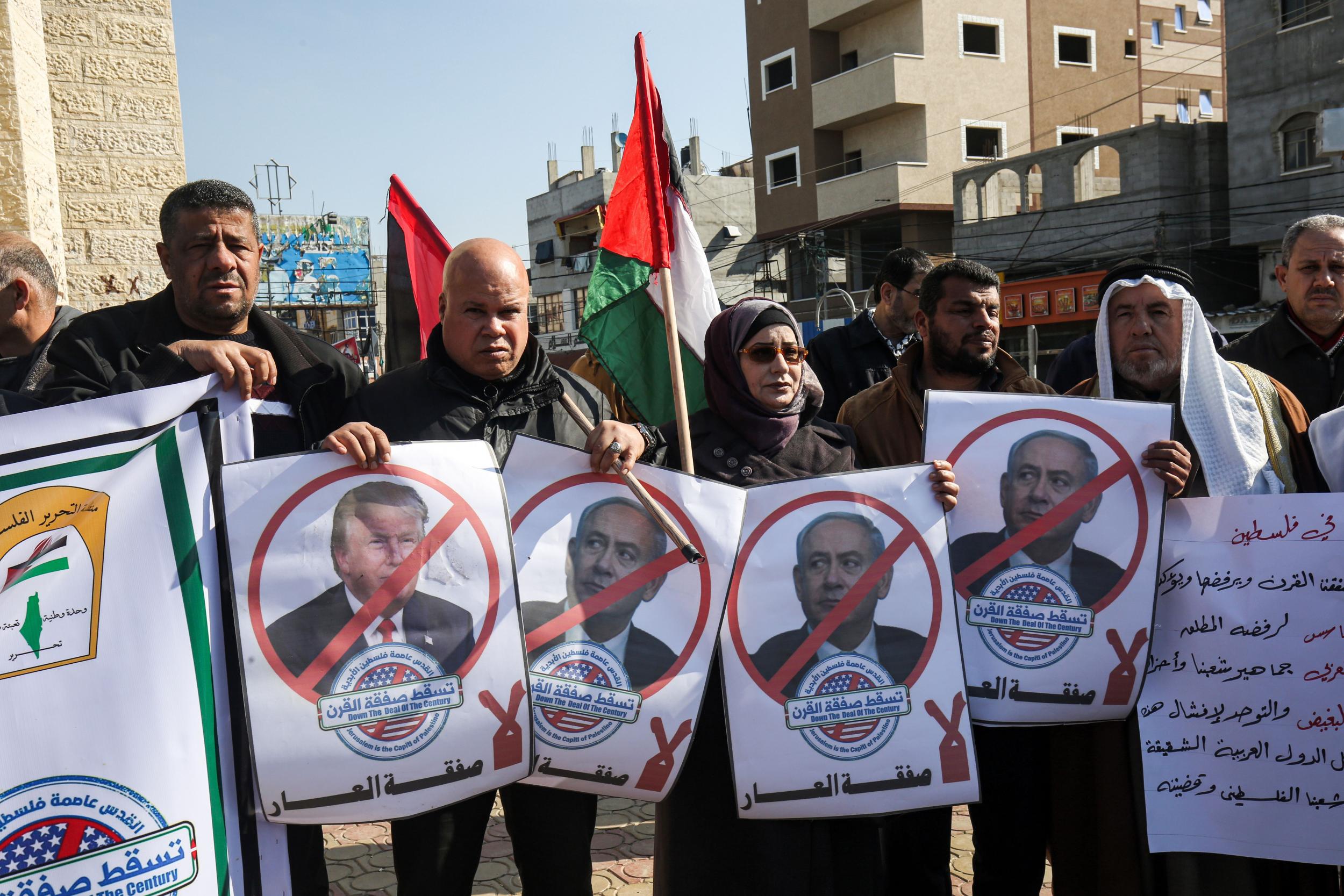 Palestinian demonstrators chant slogans while holding portraits of Trump and Netanyahu, during a protest against Trump’s expected announcement of a peace plan, in Gaza (AFP via Getty)