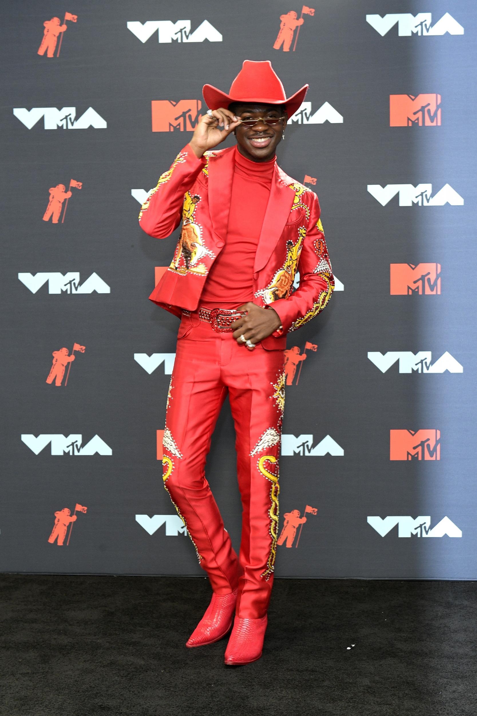 The 'Old Town Road' singer painted the town red at the awards ceremony in an ornate ensemble, which featured a red, embroidered suit by Union Western Clothing, a gem-studded belt by B.B. Simon, red boots by P.S. Kaufman, and, of course, a red cowboy hat by Gladys Tamez.