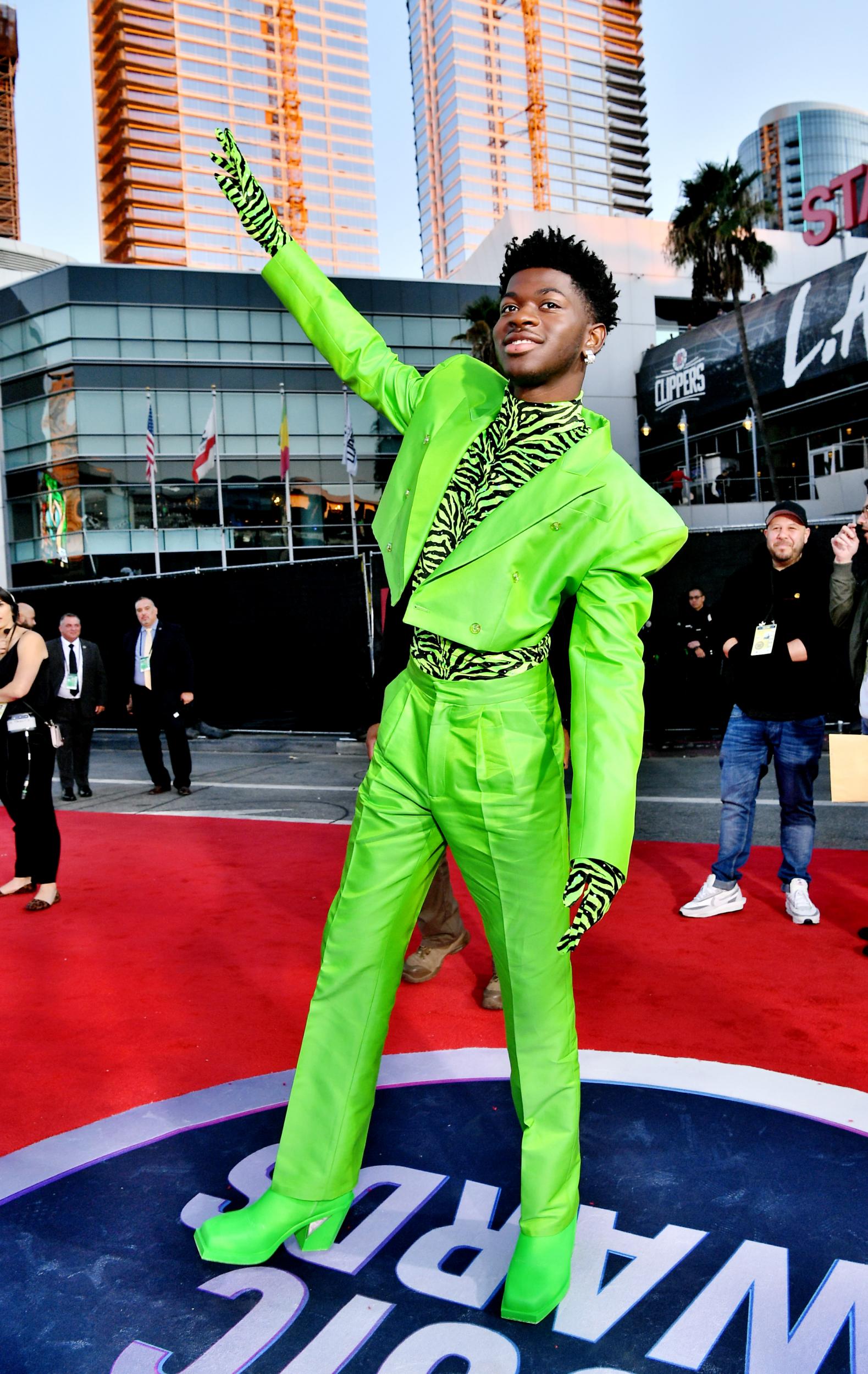 The rapper appeared to take fashion inspiration from Batman villain Riddler, known in DC comic books for his head-to-toe green garb. Lil Nas X stood out on the red carpet in the neon design by Christopher John Rogers.