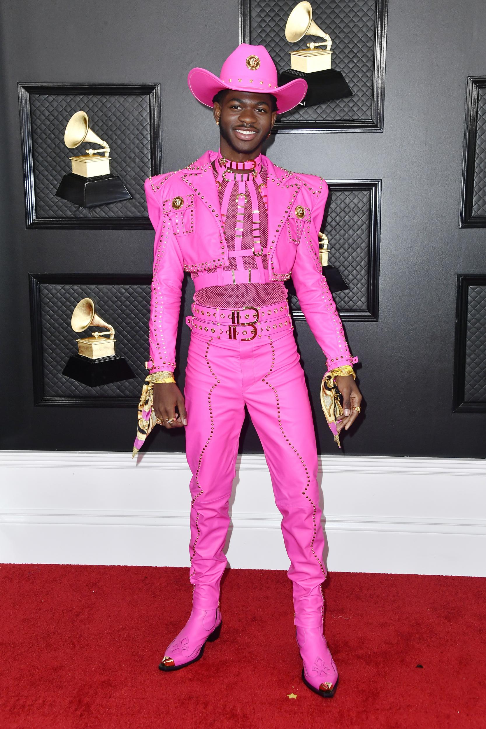 On the night he became a Grammy Award-winning artist, Lil Nas X made the red carpet his own in a hot pink custom-made Atelier Versace suit, complete with a matching cowboy hat in keeping with his signature style.