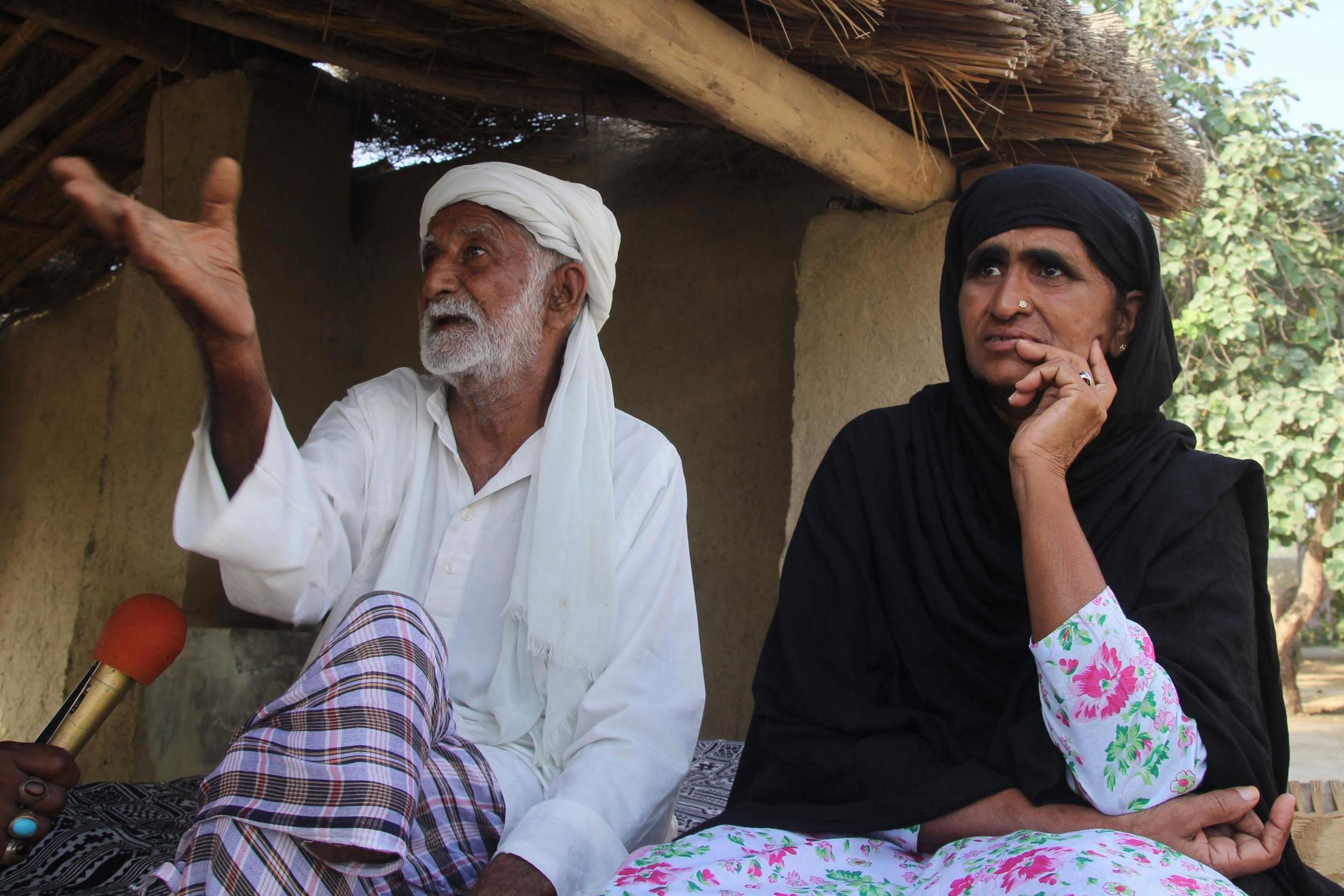 Anwar Bibi, right, and Mohammad Azeem, left, mother and father of Baloch (AFP/Getty)