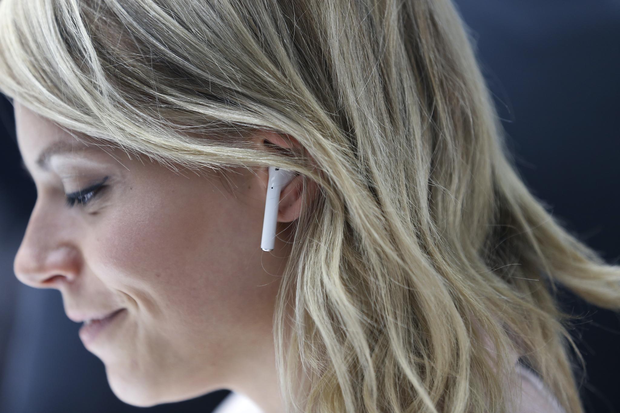 An attendee wears an Apple AirPods during a launch event on September 7, 2016 in San Francisco, California