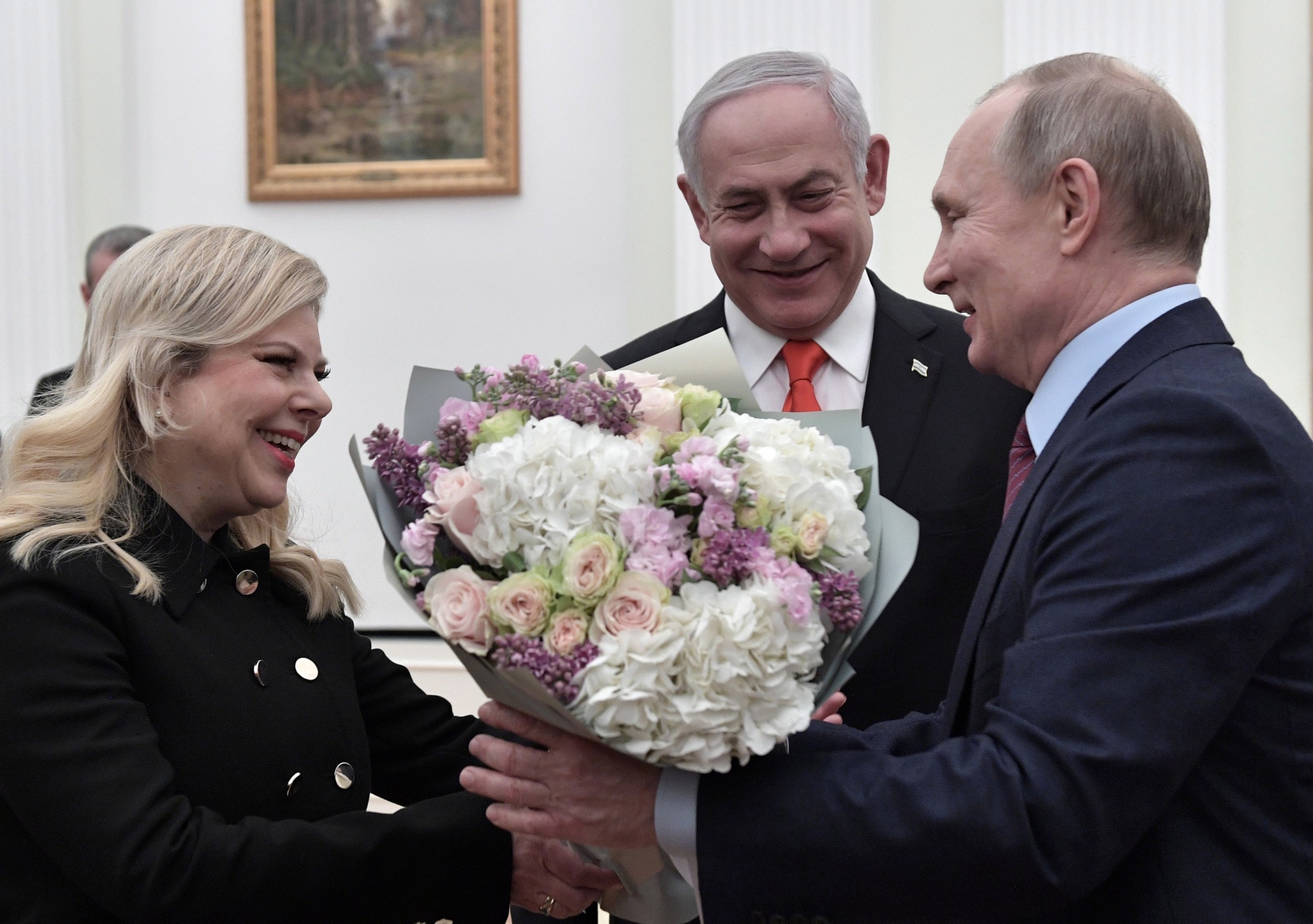 Benjamin Netanyahu and his wife Sara receive flowers from Putin during their meeting in the Kremlin in Moscow