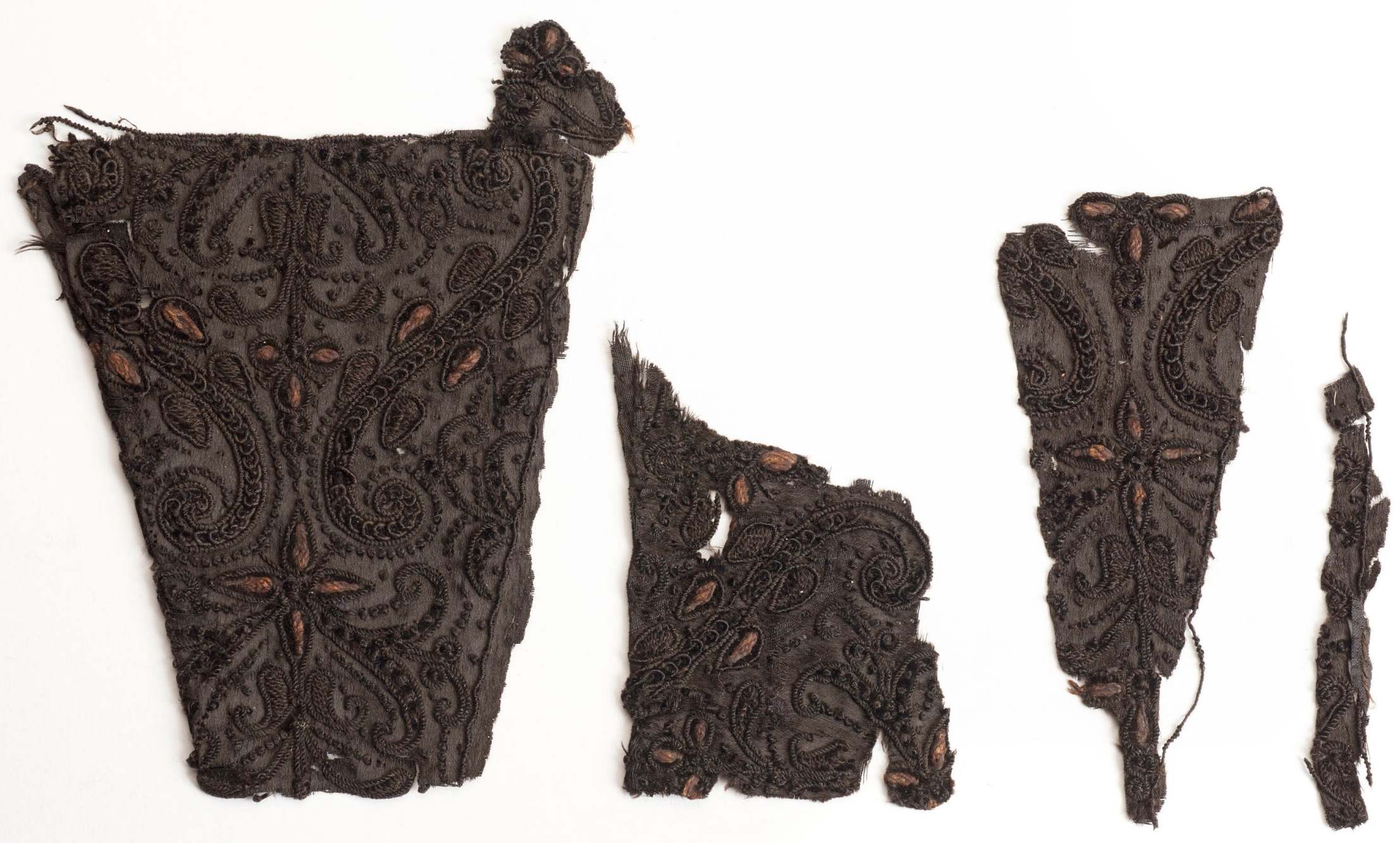 Four fragments of a cloak, said to have been worn by Charles I at his execution