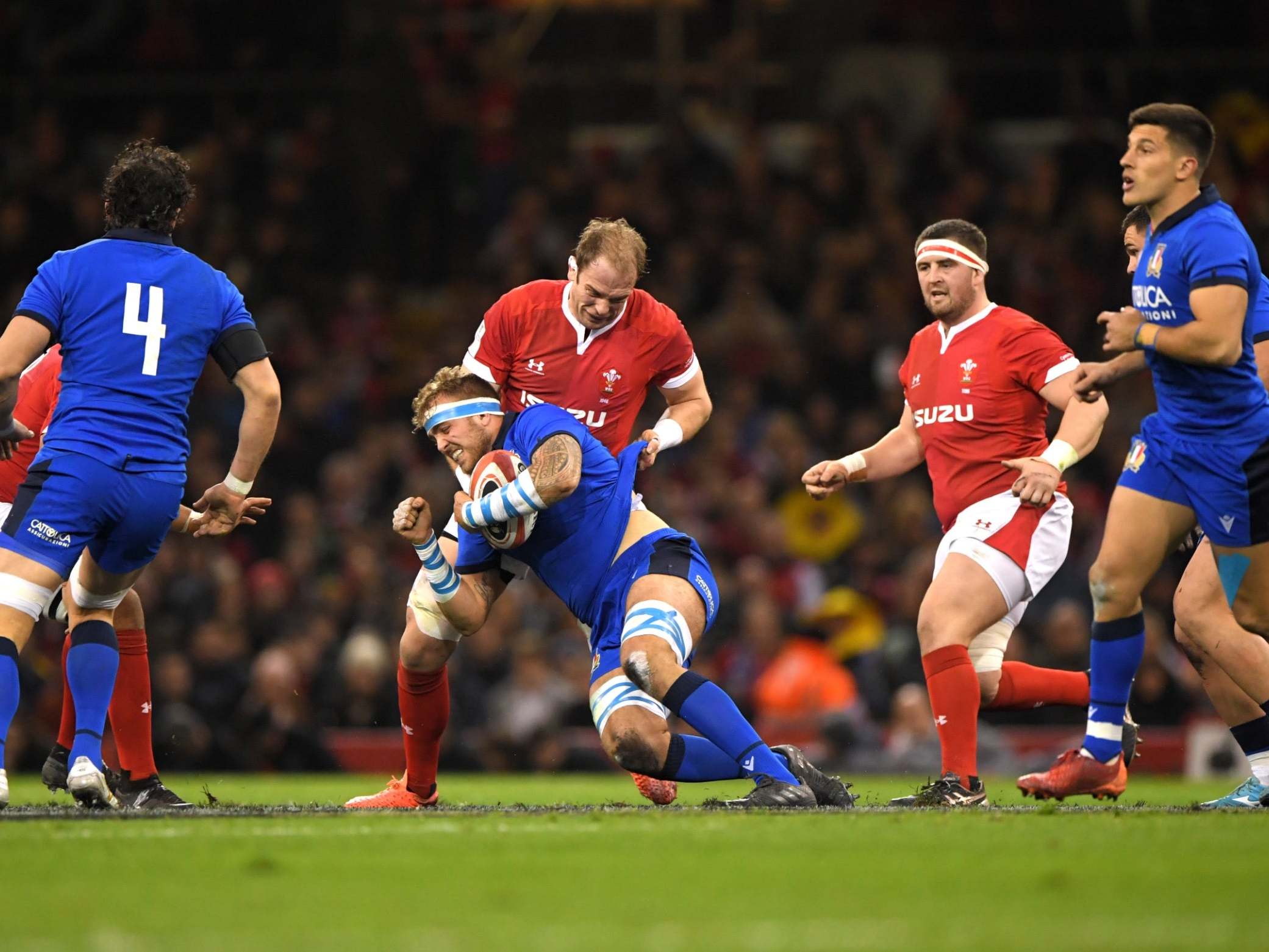 Niccolo Cannone of Italy is tackled by Alun Wyn Jones