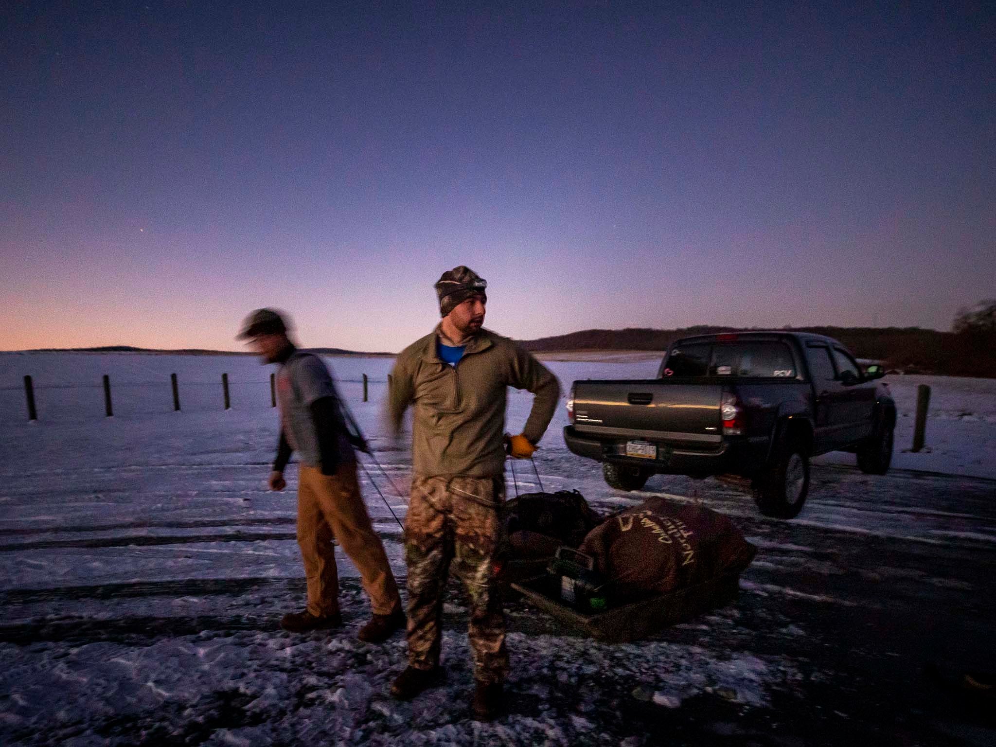 Hunters haul sleds of shooting equipment