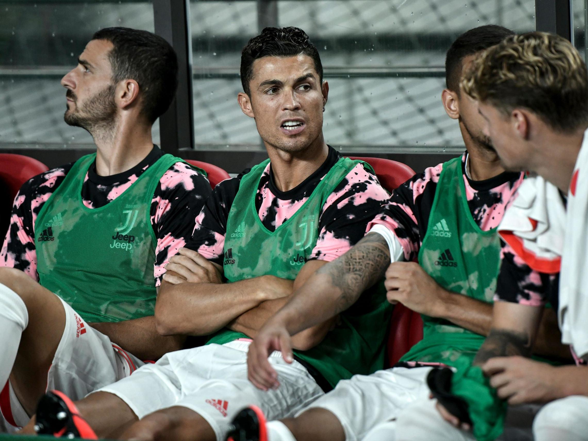 Cristiano Ronaldo sits on the team bench