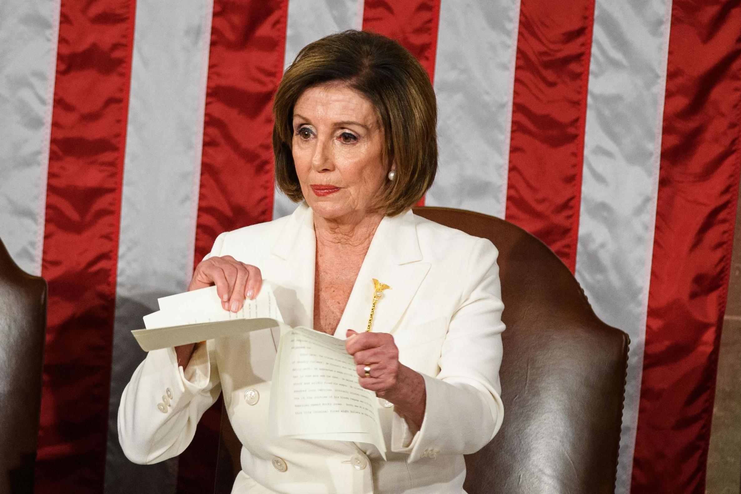 Nancy Pelosi ripped up a copy of Donald Trump's speech behind him