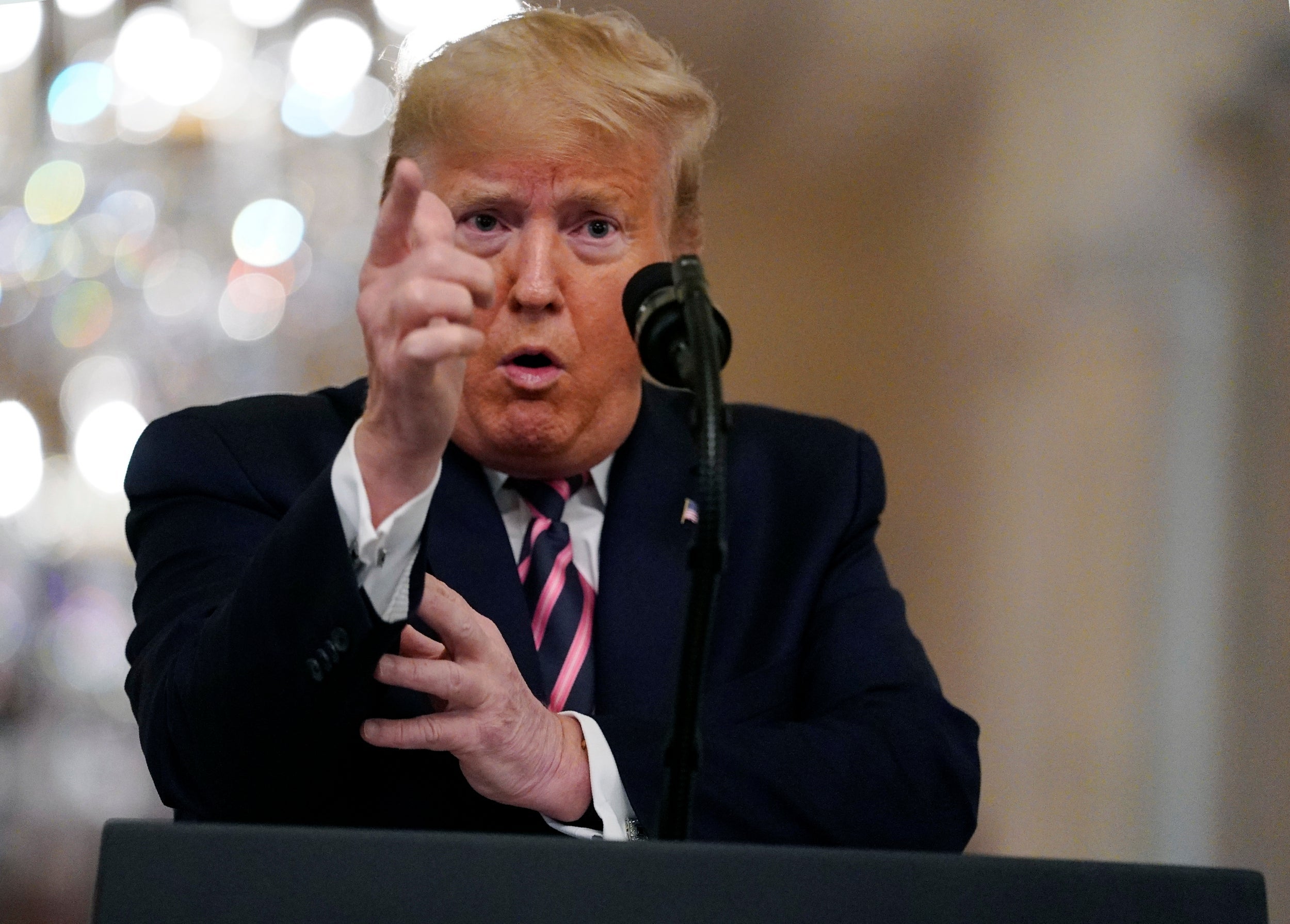 Donald Trump gestures during a televised speech at the White House following his Senate impeachment acquittal