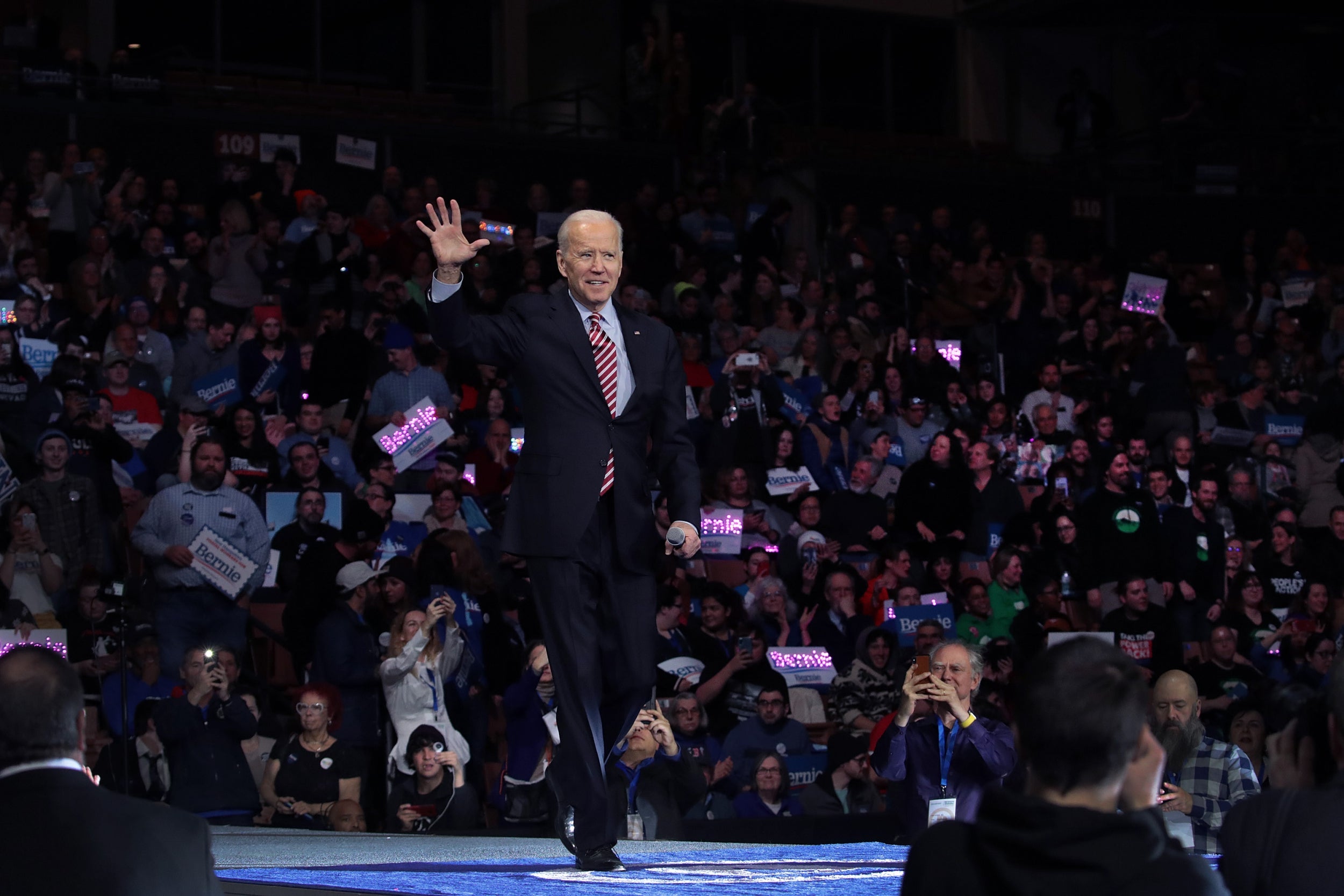 Joe Biden waves during his speech at the 100 Club Dinner in Manchester, New Hampshire, ahead of the Democratic primary