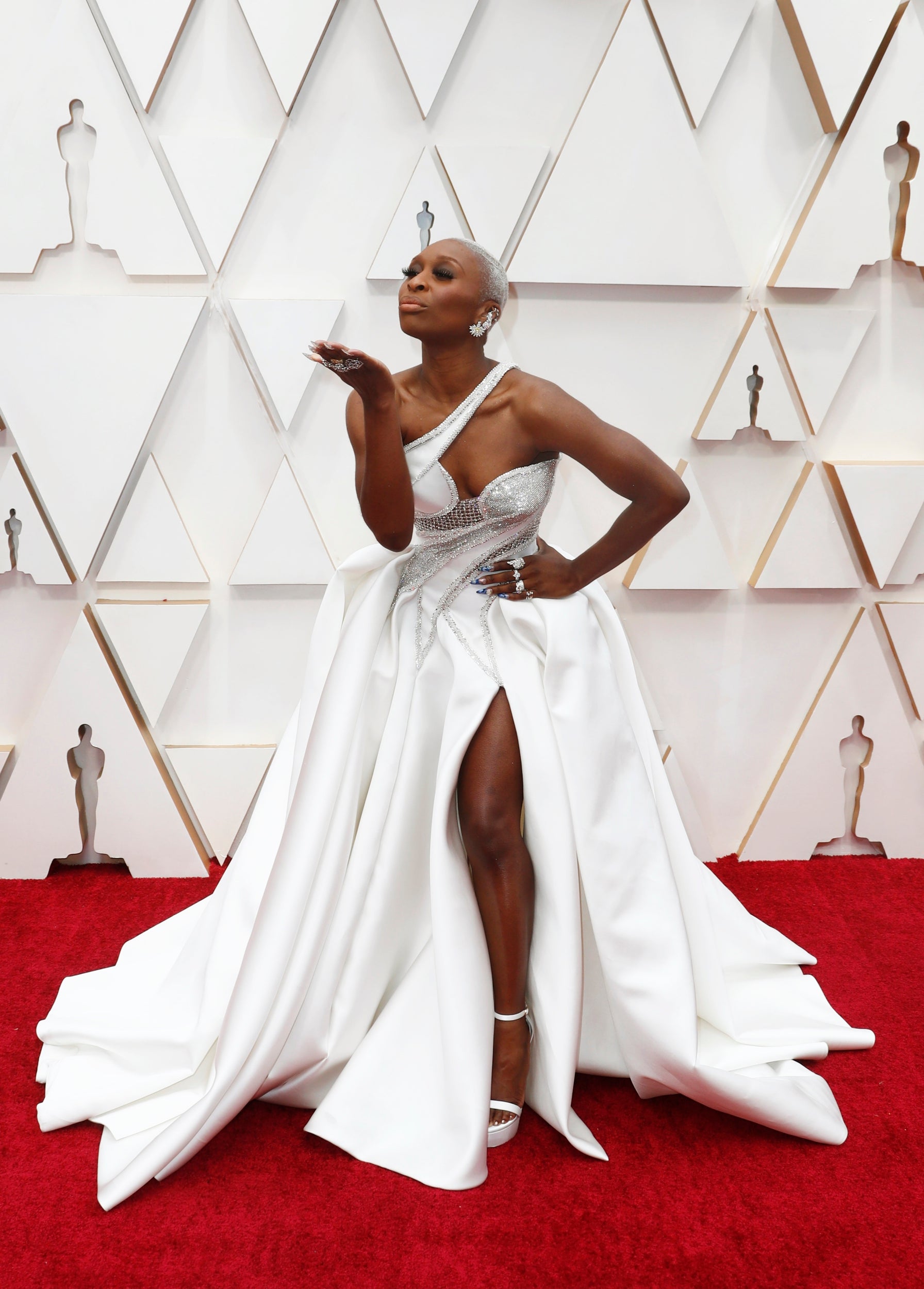Cynthia Erivo blew a kiss as she posed in her futuristic white and silver Versace gown and Maria Tash jewellery.