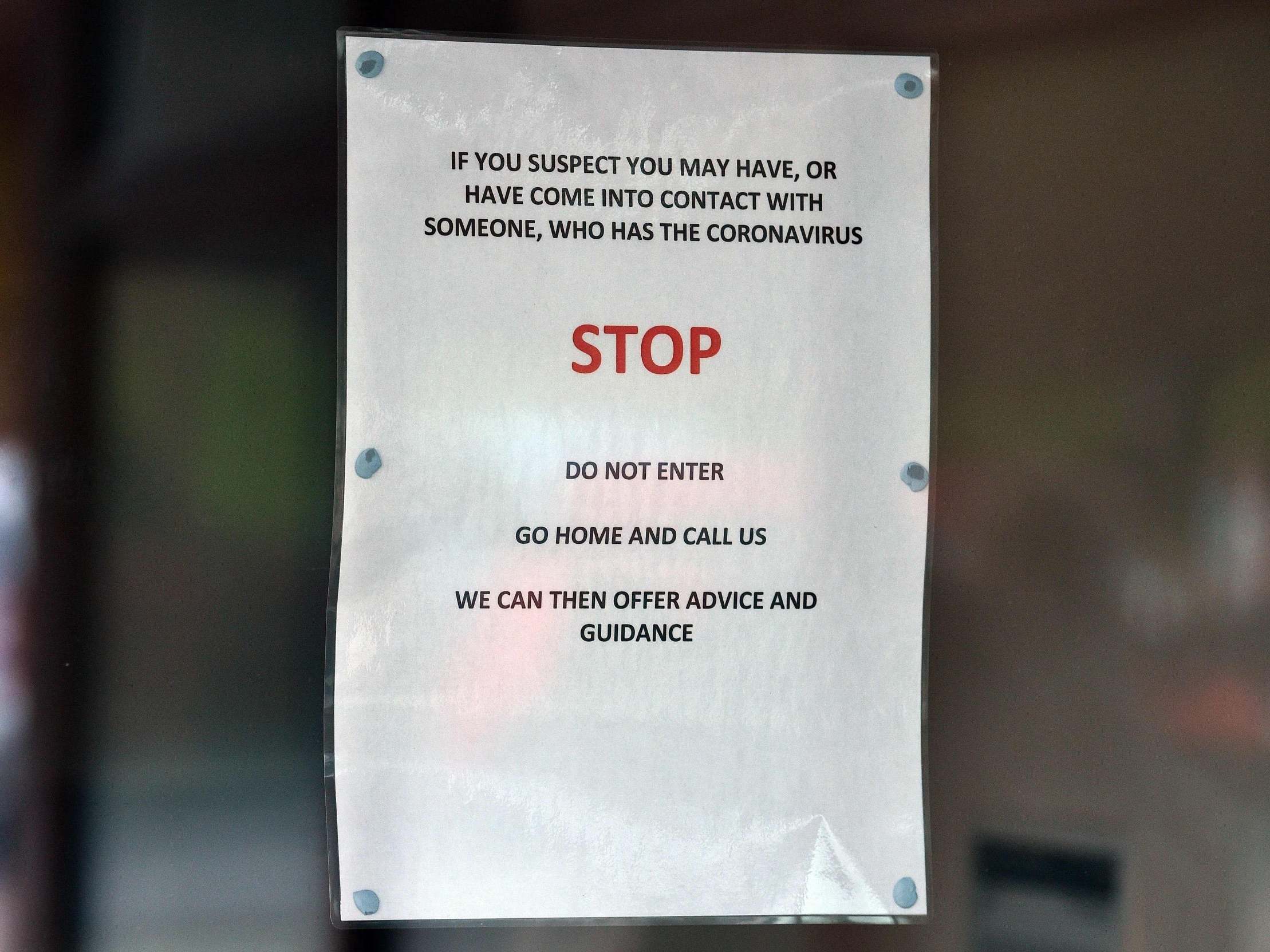 Signs warning patients about the novel coronavirus outbreak pictured at The County Oak Medical Centre, in Brighton, 10 February, 2020.