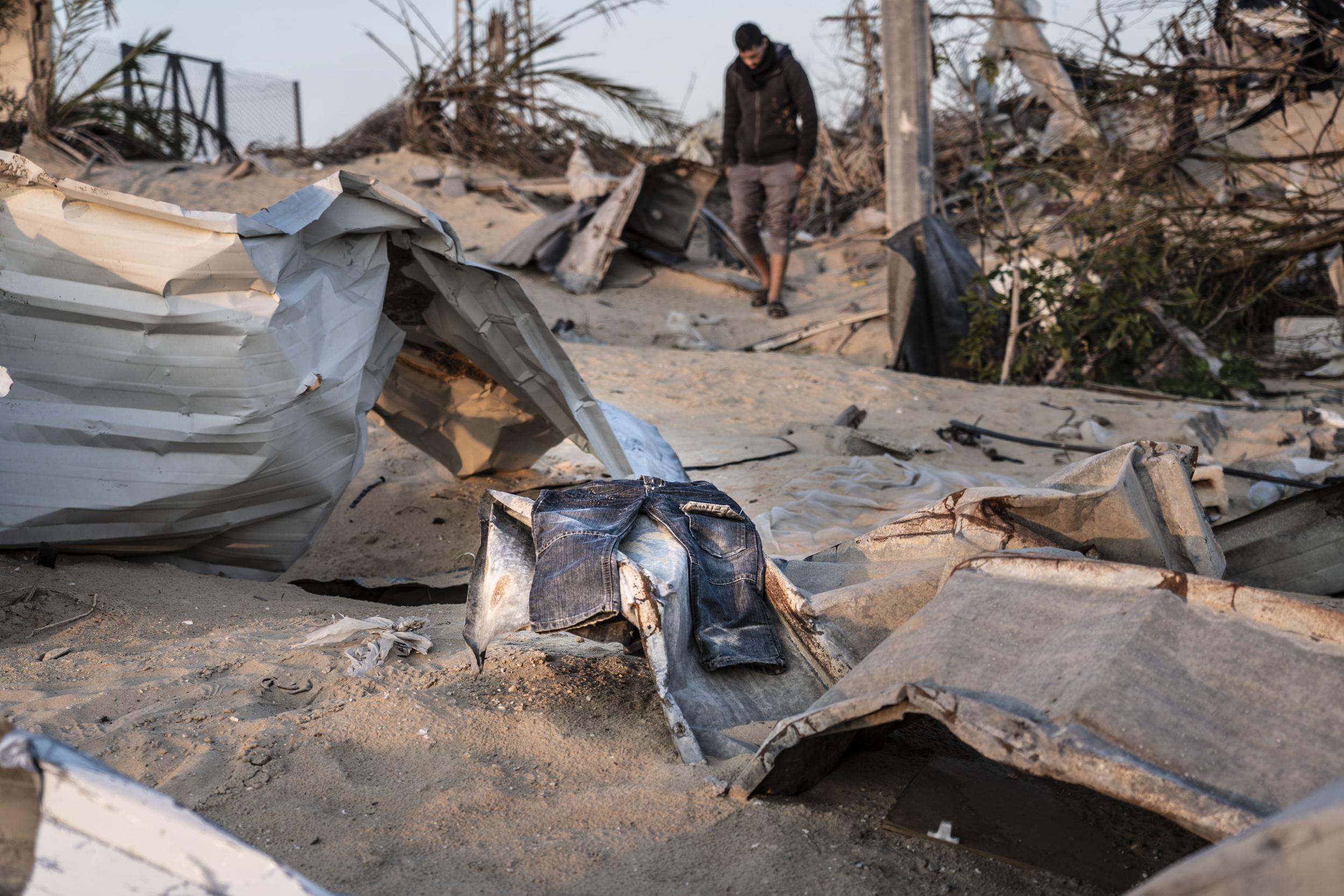 A pair of children’s jeans is one of the few items that survived the airstrike