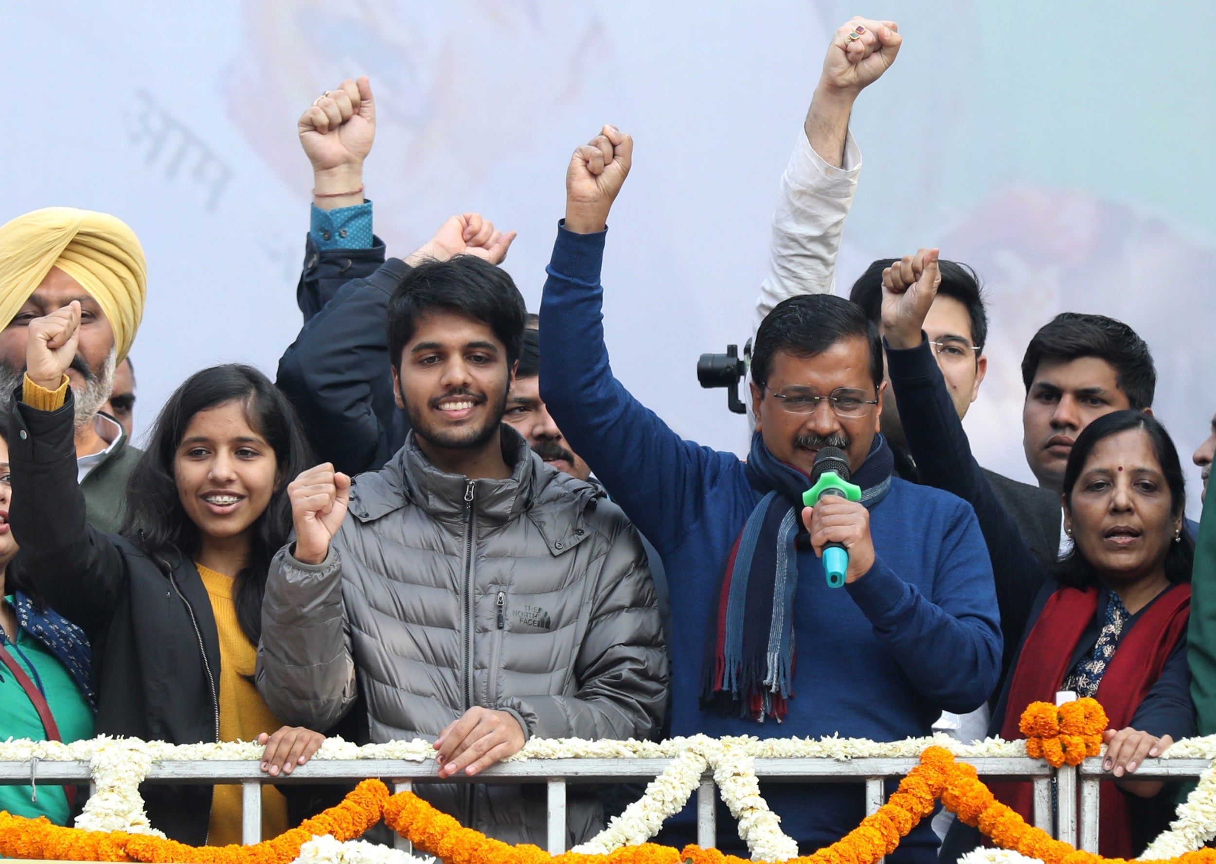 Arvind Kejriwal (second from right), AAP leader and chief minister of Delhi, celebrates with his wife Sunita Kejriwal (right) and their children