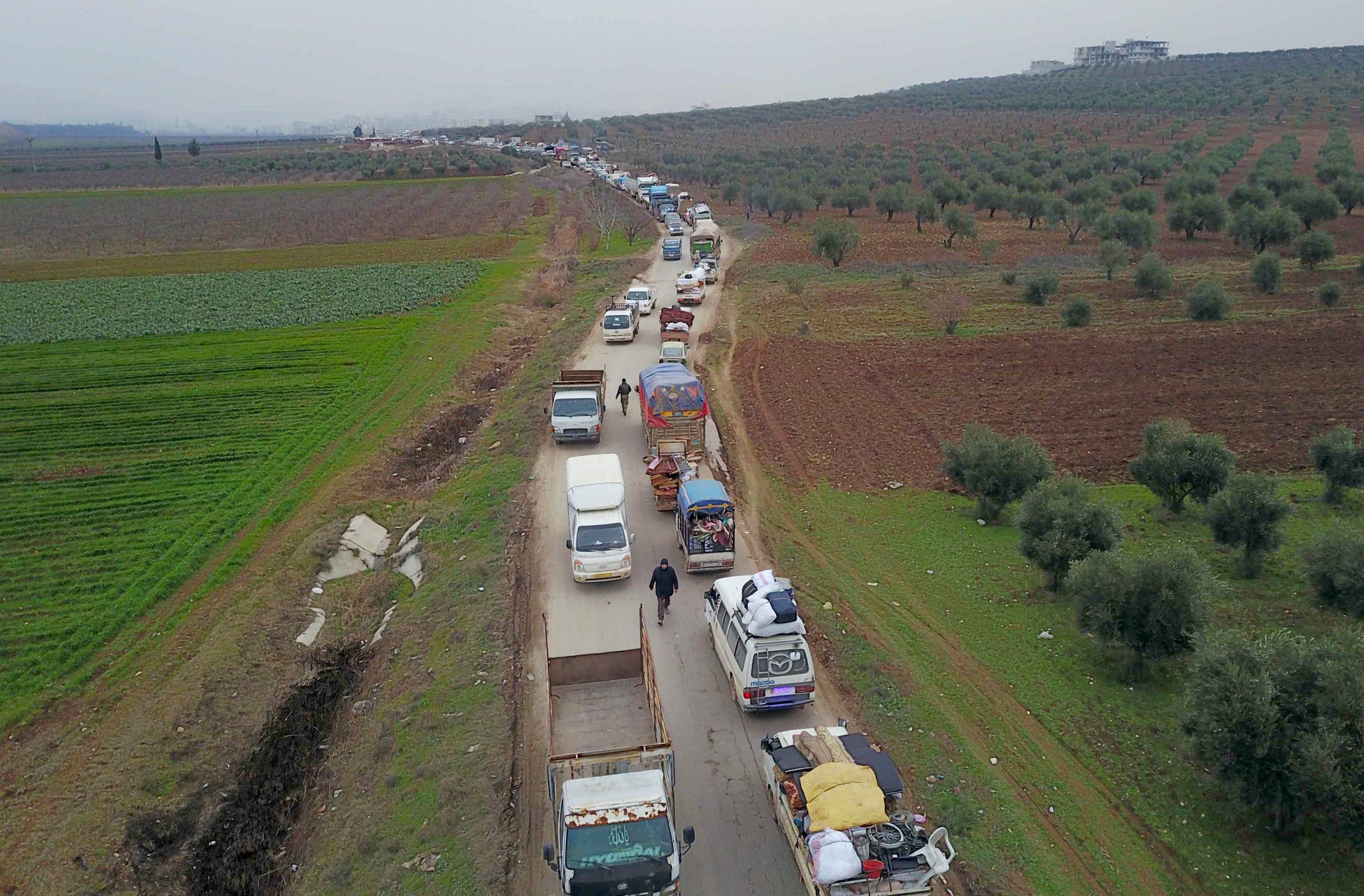 Civilians flee from Idlib to find safety inside Syria near the border with Turkey