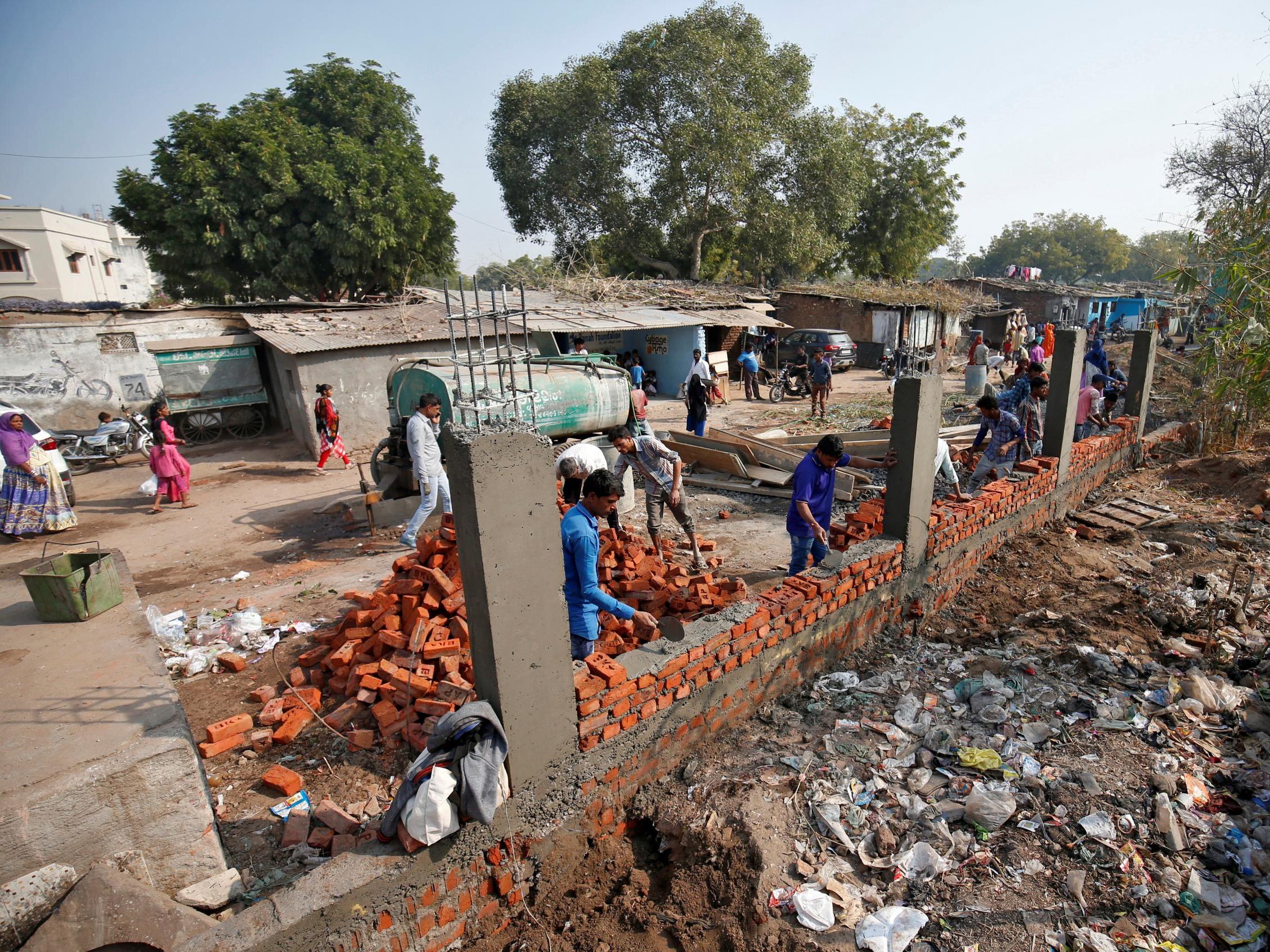 Constructors building the wall in Ahmedabad India 13 February