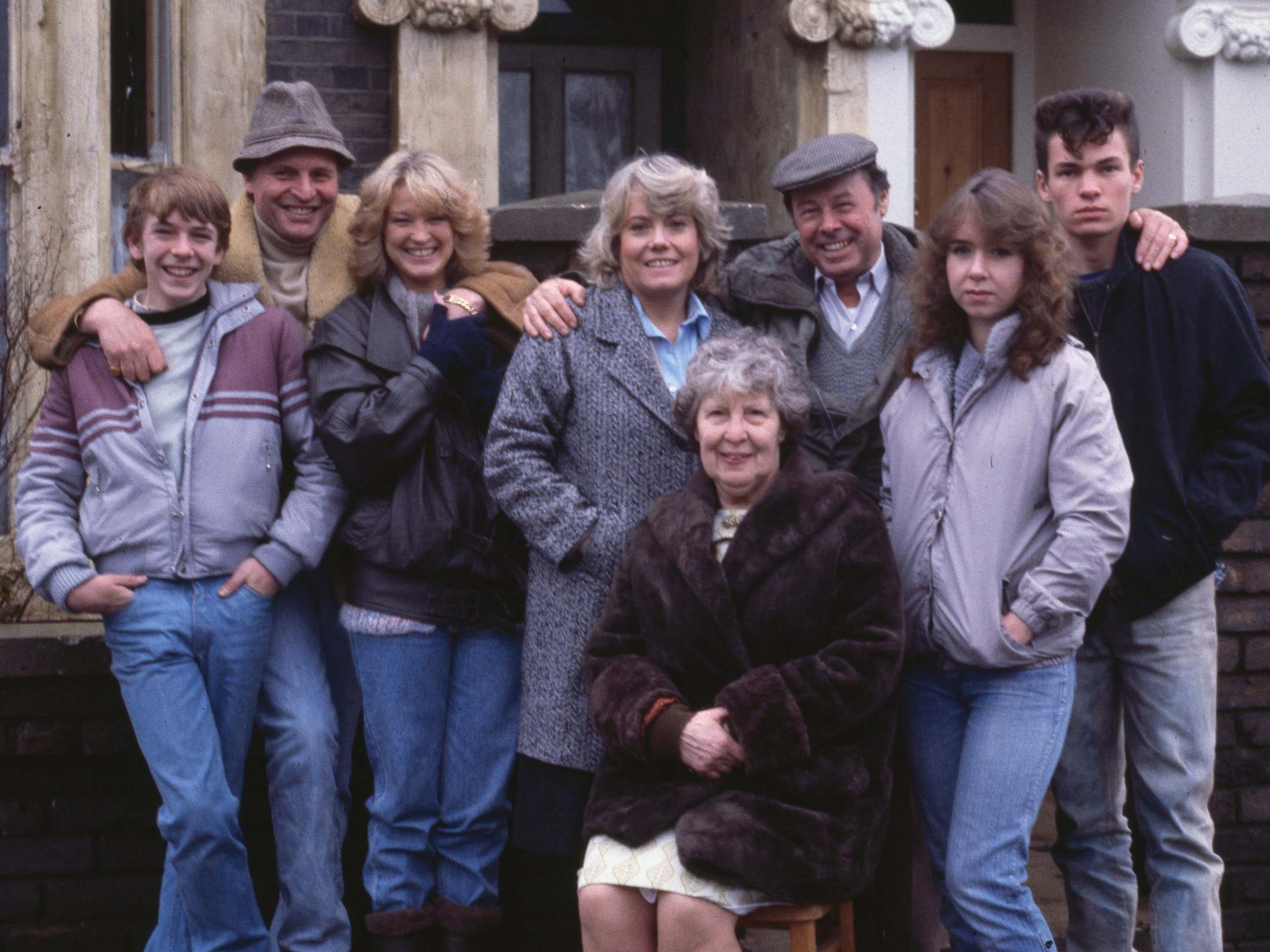 L-R: Adam Woodyatt, Peter Dean, Gillian Taylforth, Wendy Richard, Anna Wing, Bill Treacher, Susan Tully and David Scarboro on the set of EastEnders, November 1984