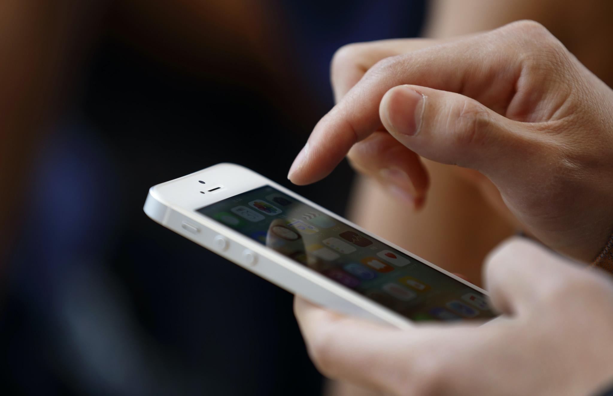 A customer tries an Apple Inc. iPhone SE at the company's Omotesando store on March 31, 2016 in Tokyo, Japan