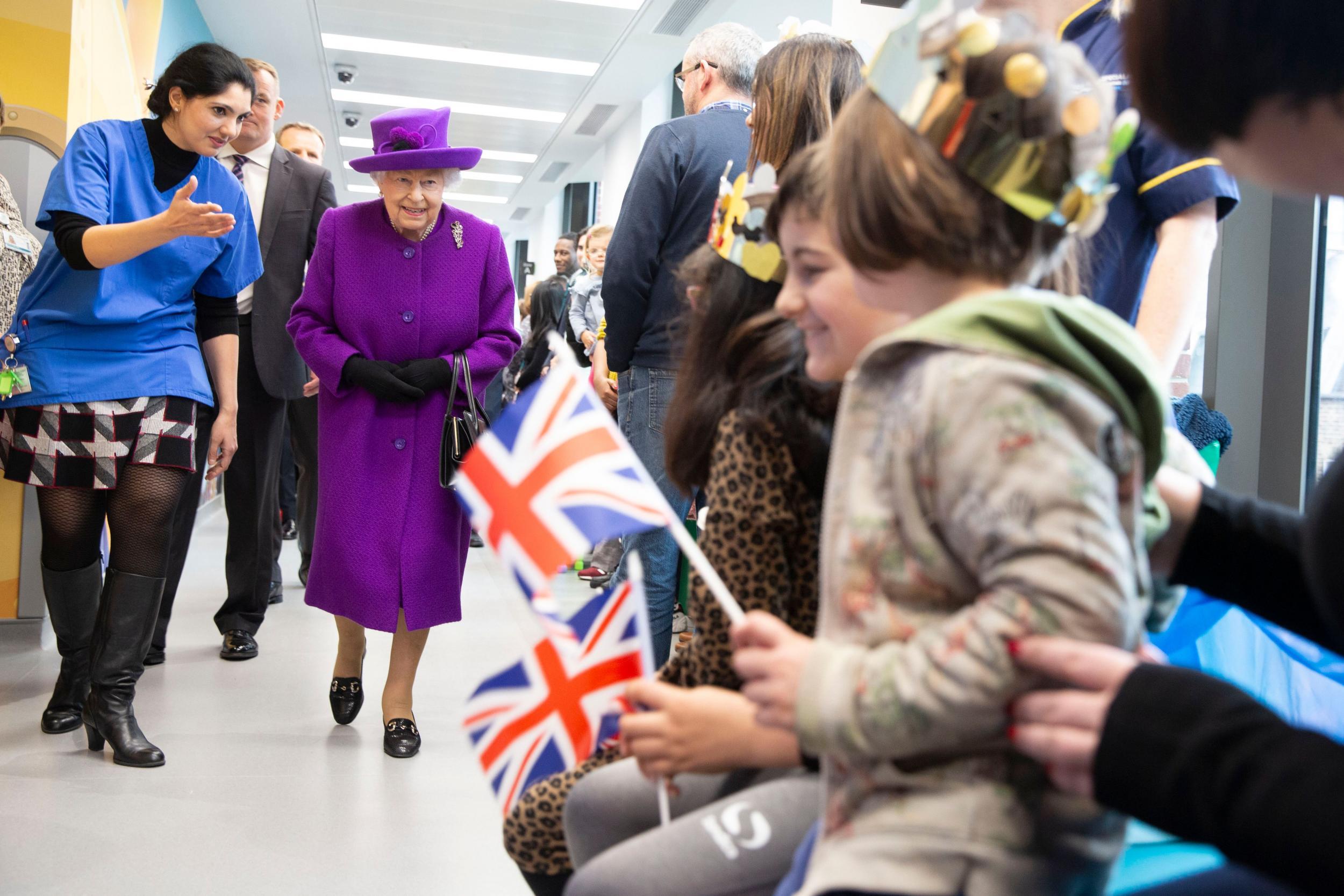 Children greeted the royal wearing gold and silver paper crowns (Getty)