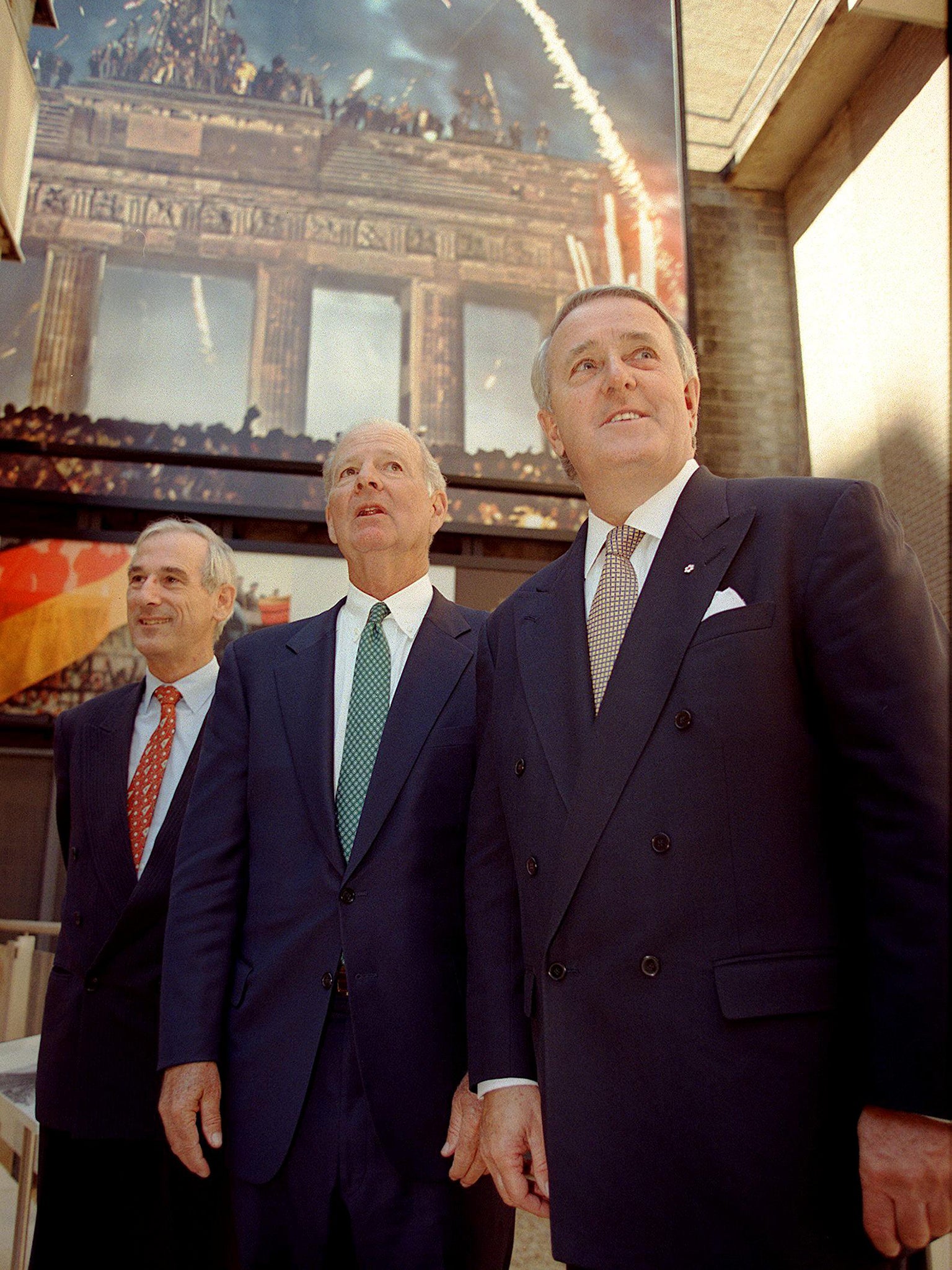 Fukuyama was an aide to former US secretary of state James Baker (centre), here on a tour of the Berlin Wall exhibit in Freedom Park in 1999 (AFP/Getty)