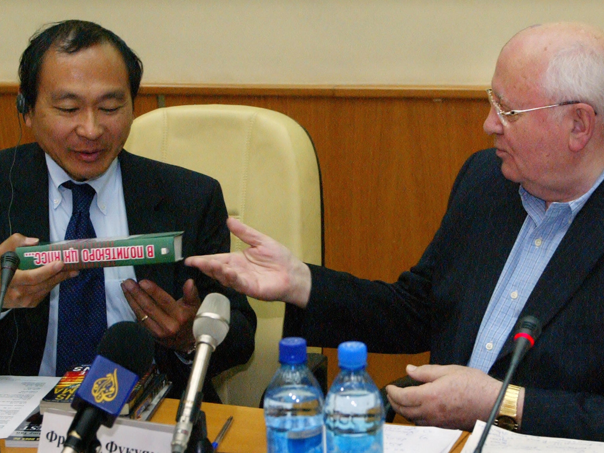 Former Soviet Union president Mikhail Gorbachev gives his book to Fukuyama during a conference in Moscow (AFP/Getty)