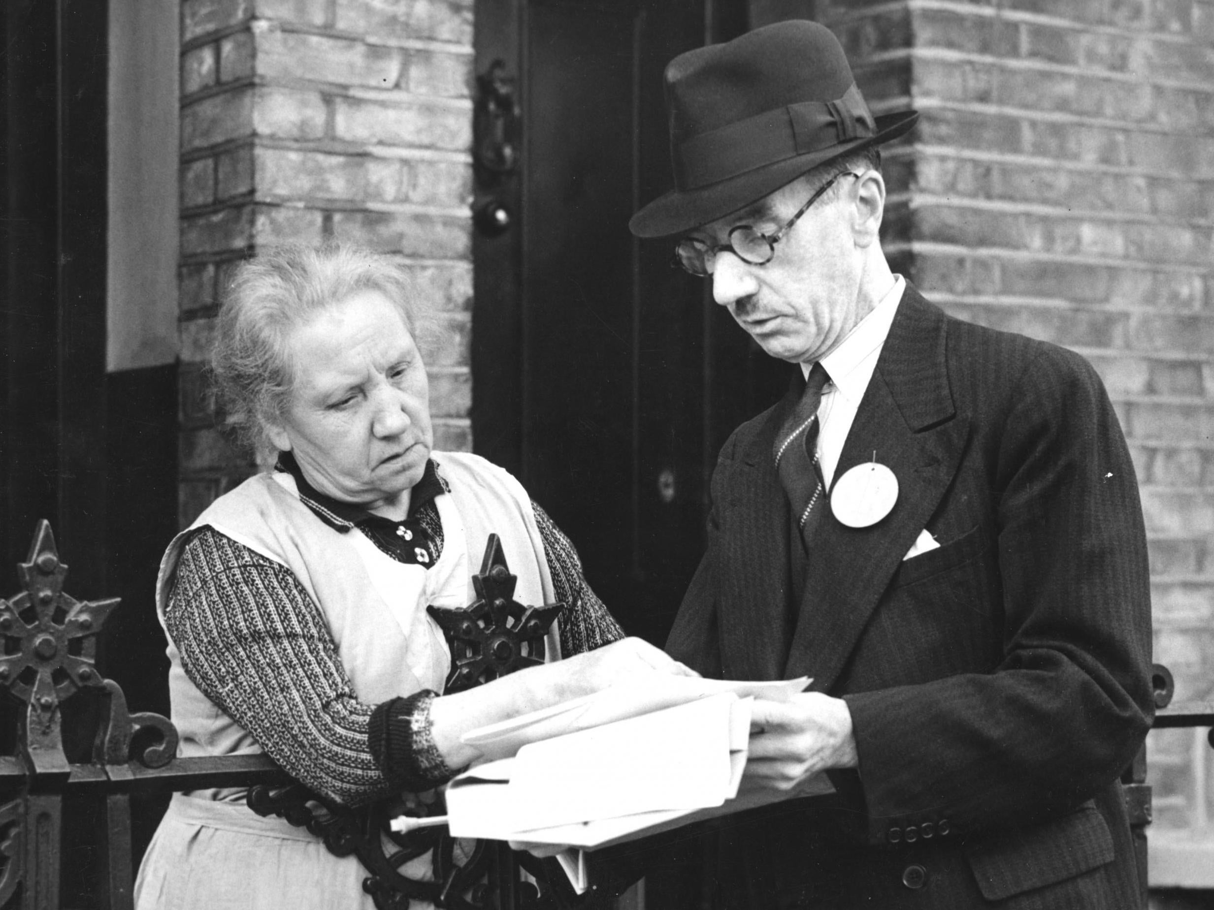 September 1939: an enumerator distributing National Register forms explains how to fill one in