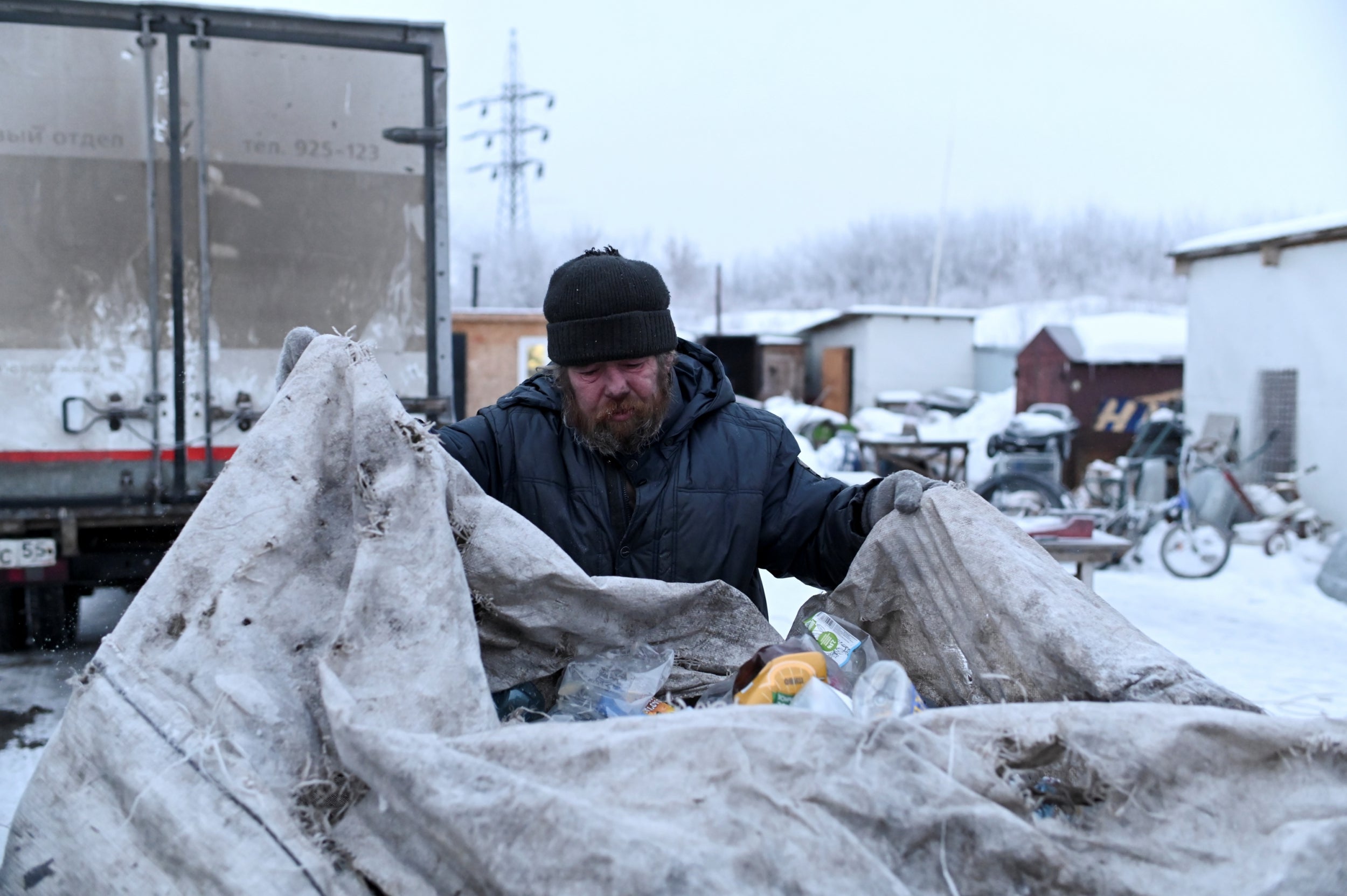 Alexei Vergunov, 46, nicknamed Lyokha Boroda (Lyokha the Beard) brings bottles and aluminium cans which he collected to exchange for payment at a recycling centre