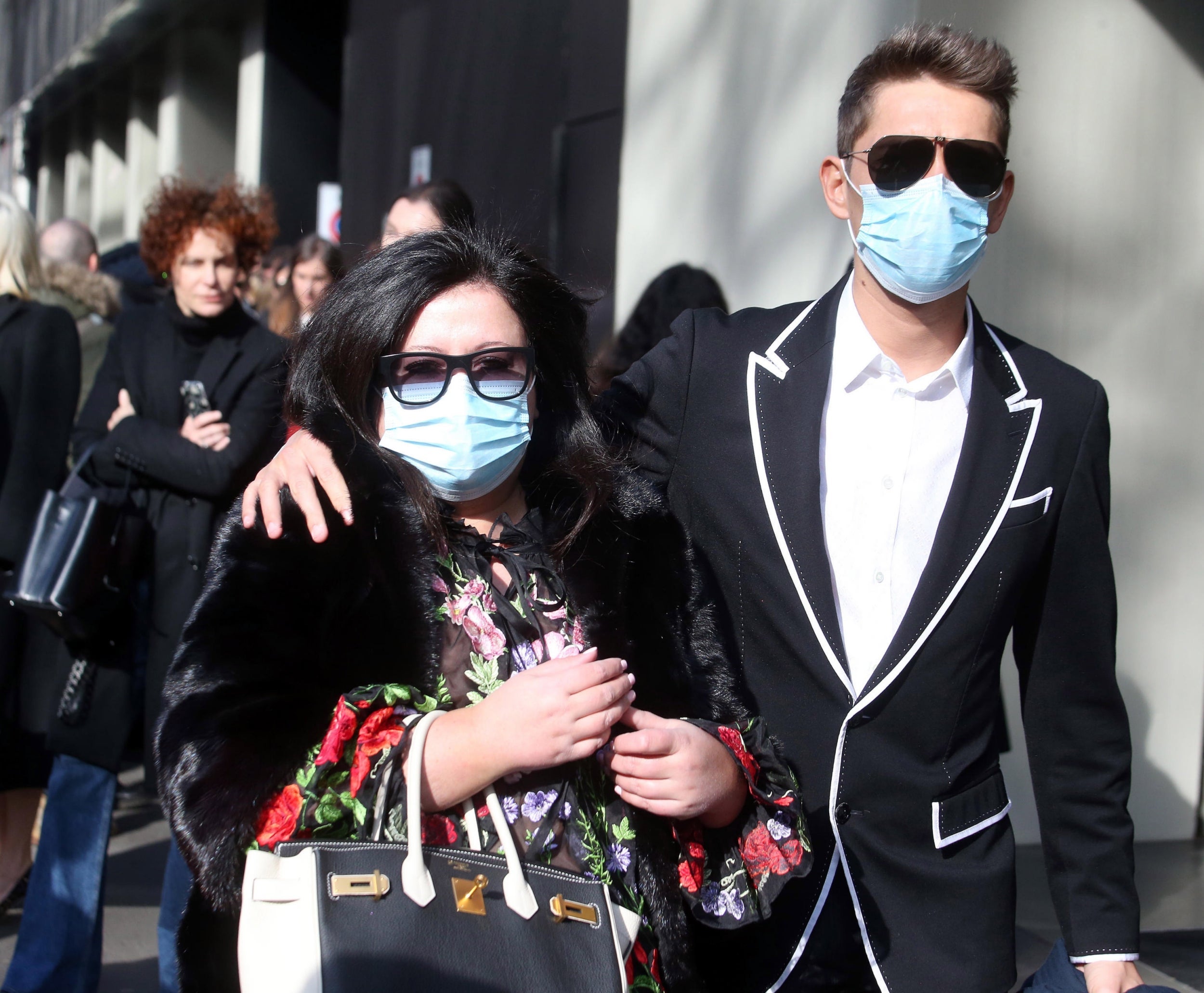 Guests wear face masks to protect against coronavirus upon arrival to attend the Dolce and Gabbana show during the Milan Fashion Week