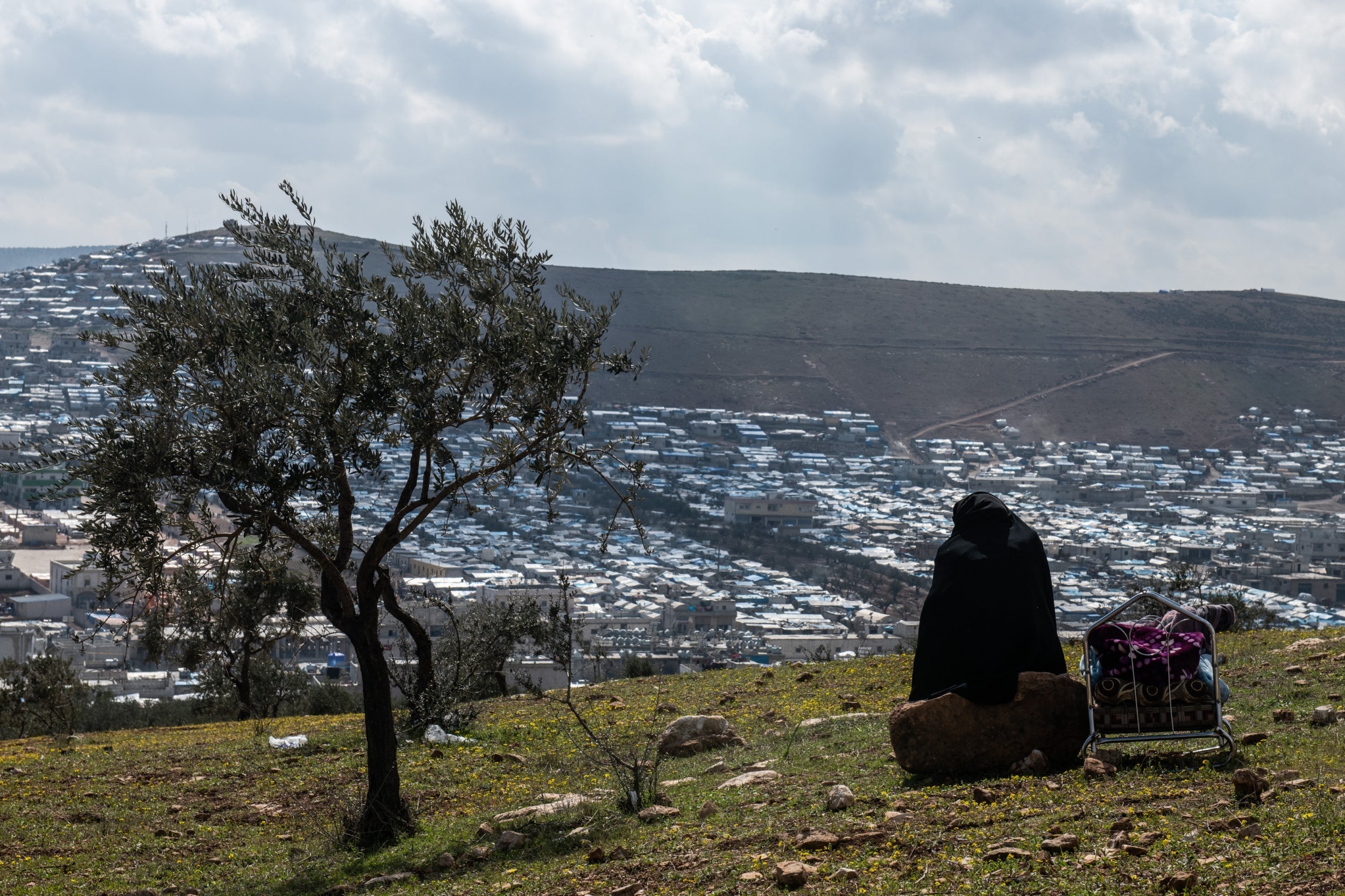 A displaced Syrian looks down on the newly built camp at Atmeh, near Idlib