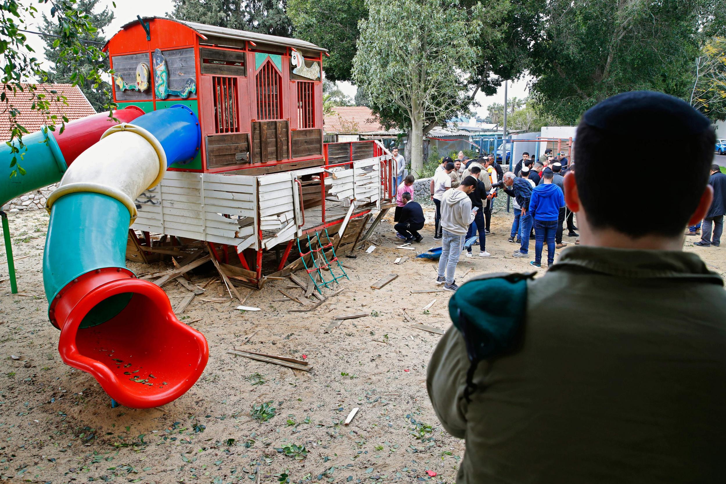 People inspect damage at a kindergarten in the southern Israeli city of Sderot, following a rocket barrage from Gaza (AFP)