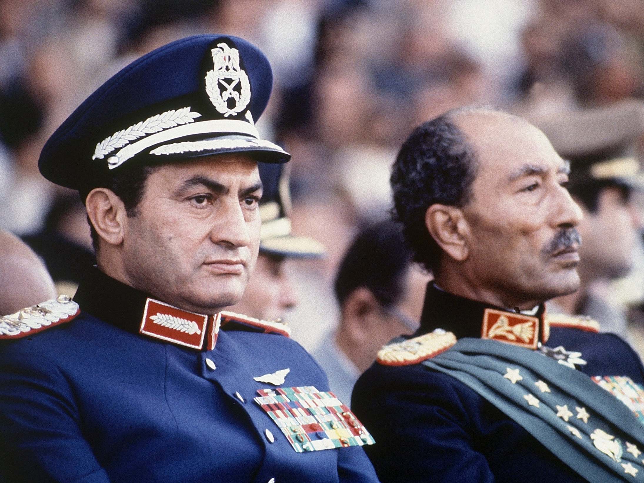 In 1981, Egyptian president Anwar Sadat, right, and vice president Hosni Mubarak watch a military parade just before soldiers opened fire from a truck, killing Sadat