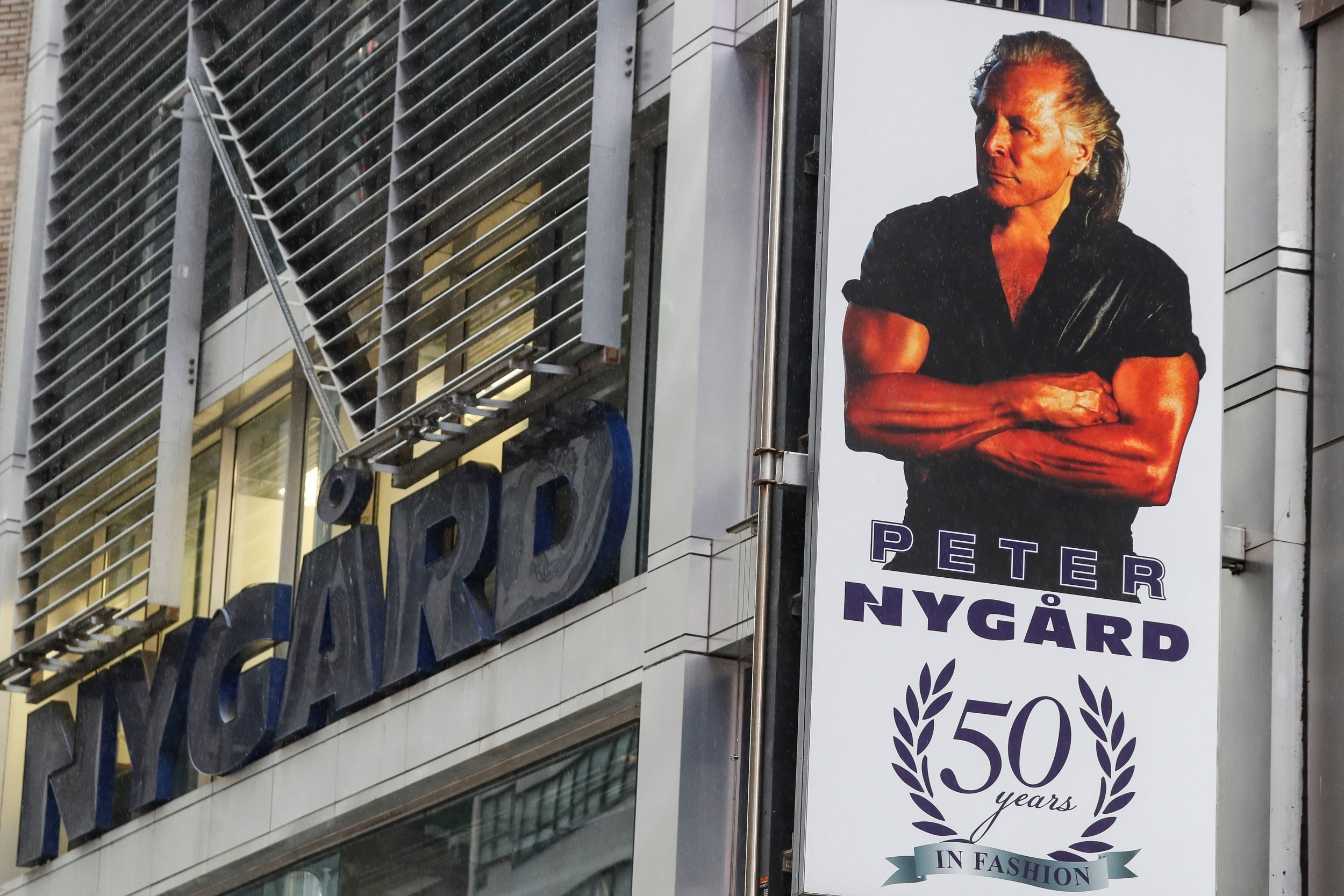 A sign featuring a picture of Peter Nygard outside his Times Square offices in New York City